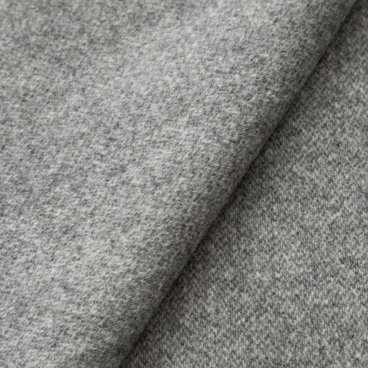 Close-up of Lanerossi Ulisse throw in heathered grey wool blend, showing folded fabric texture.