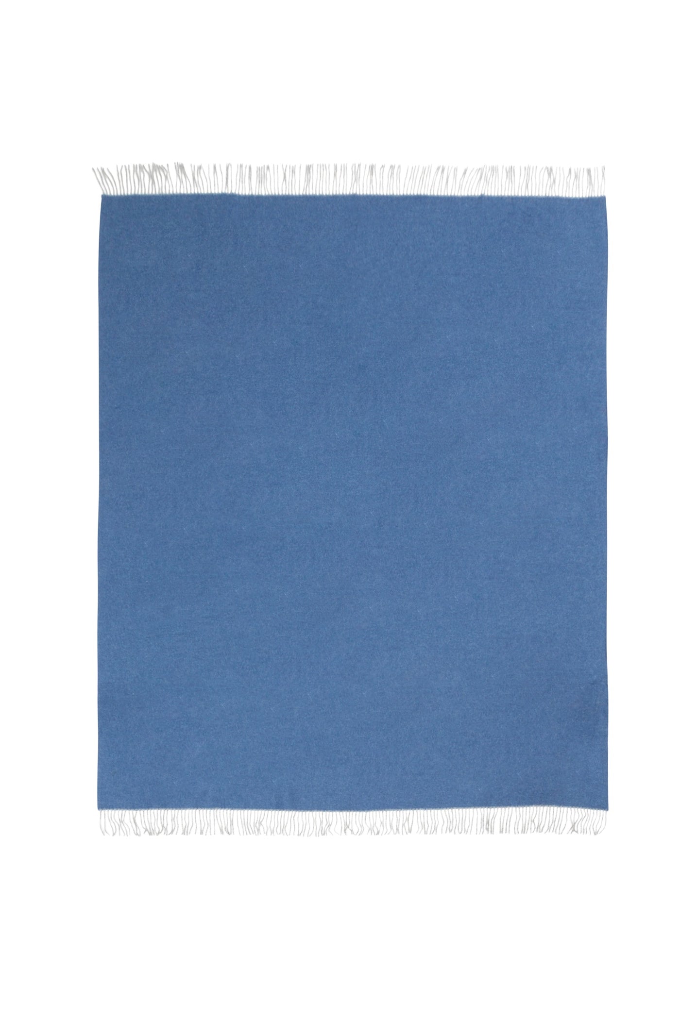 Cornflower blue Ulisse throw laid flat, showing white fringe trim along top and bottom edges.