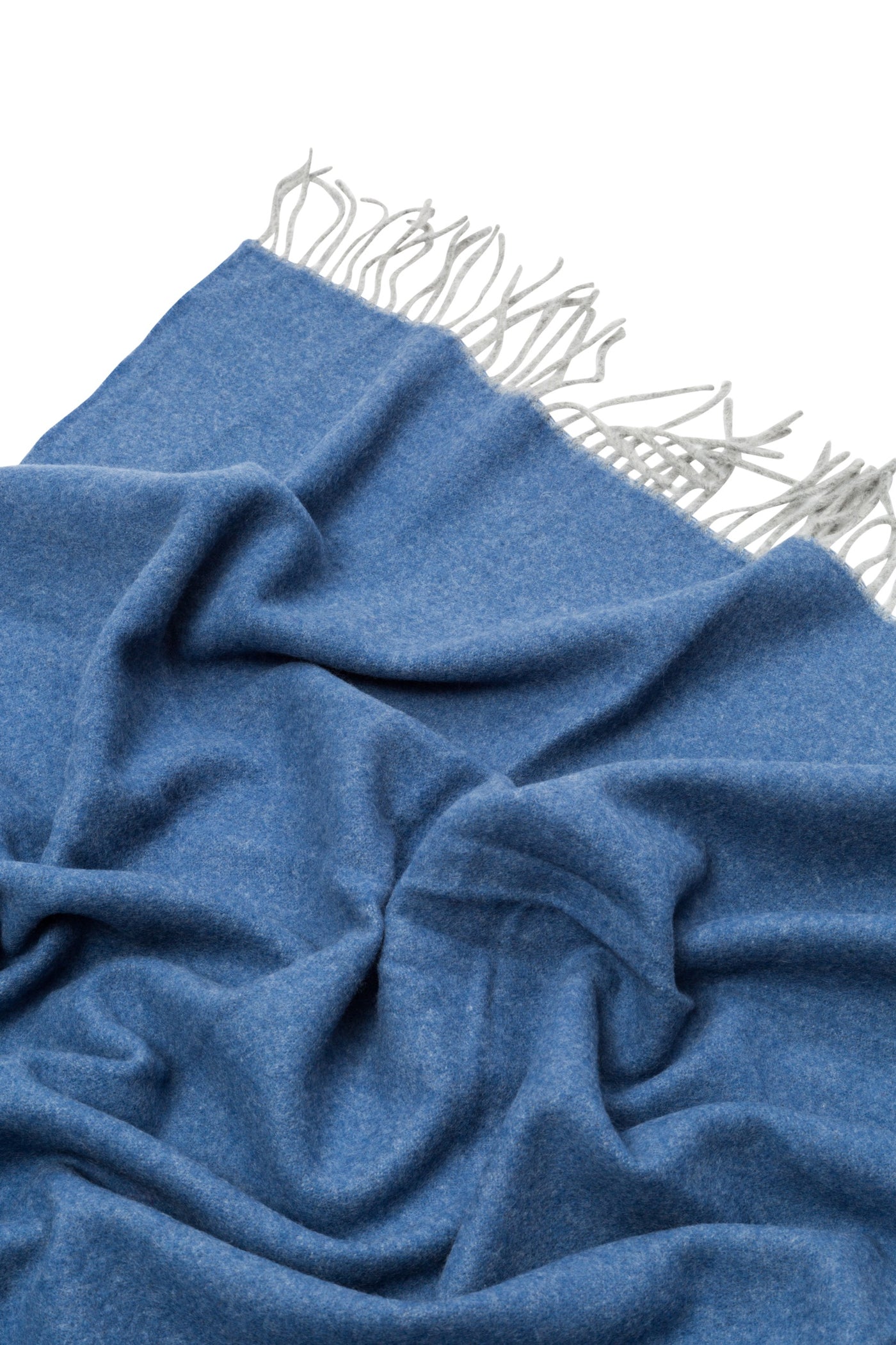 Cornflower blue woven throw with ivory knotted fringe, draped to show soft folds.