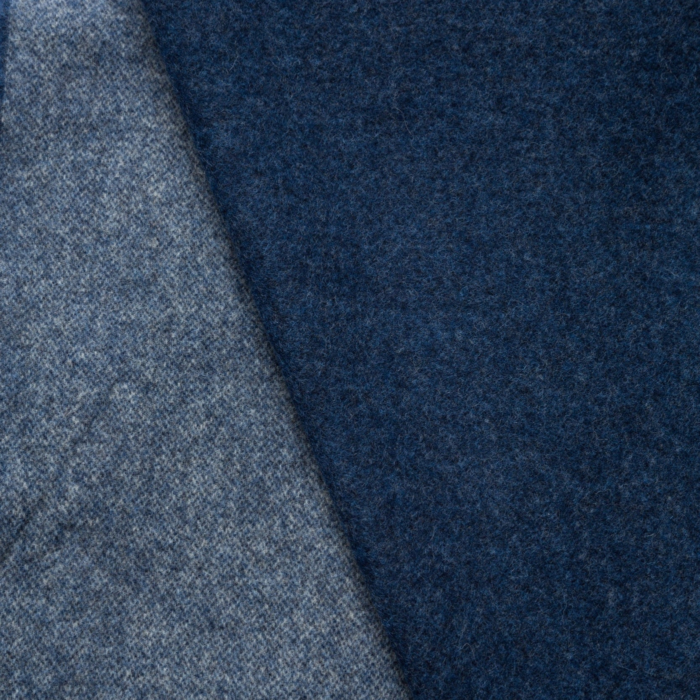 Close-up of Lanerossi Ulisse throw showing navy and grey reversible wool fabric texture.