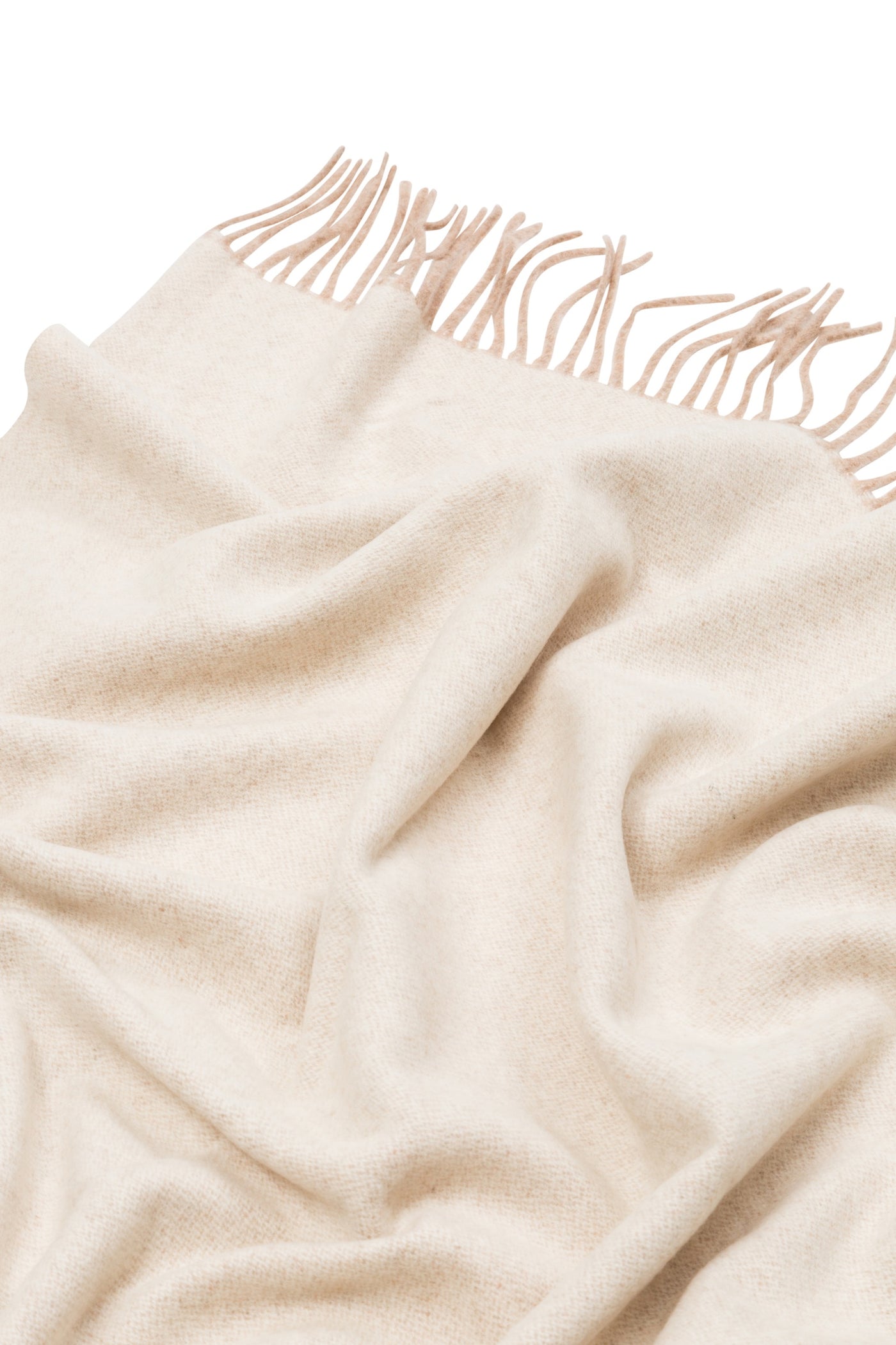Close-up of draped ivory Lanerossi Ulisse throw with knotted fringe trim detail.