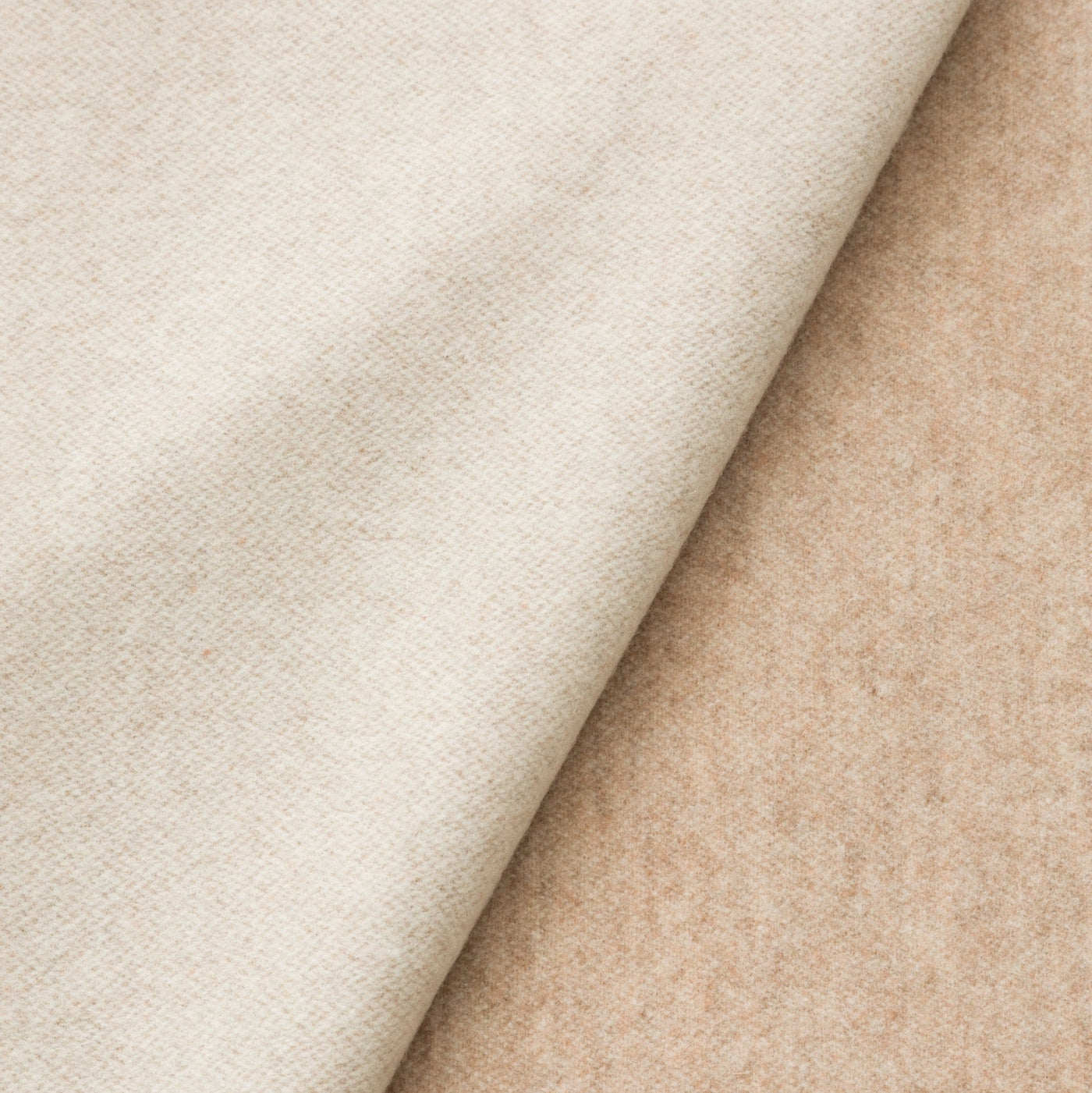 Close-up of Lanerossi Ulisse throw showing ivory face and camel reverse fabric textures.