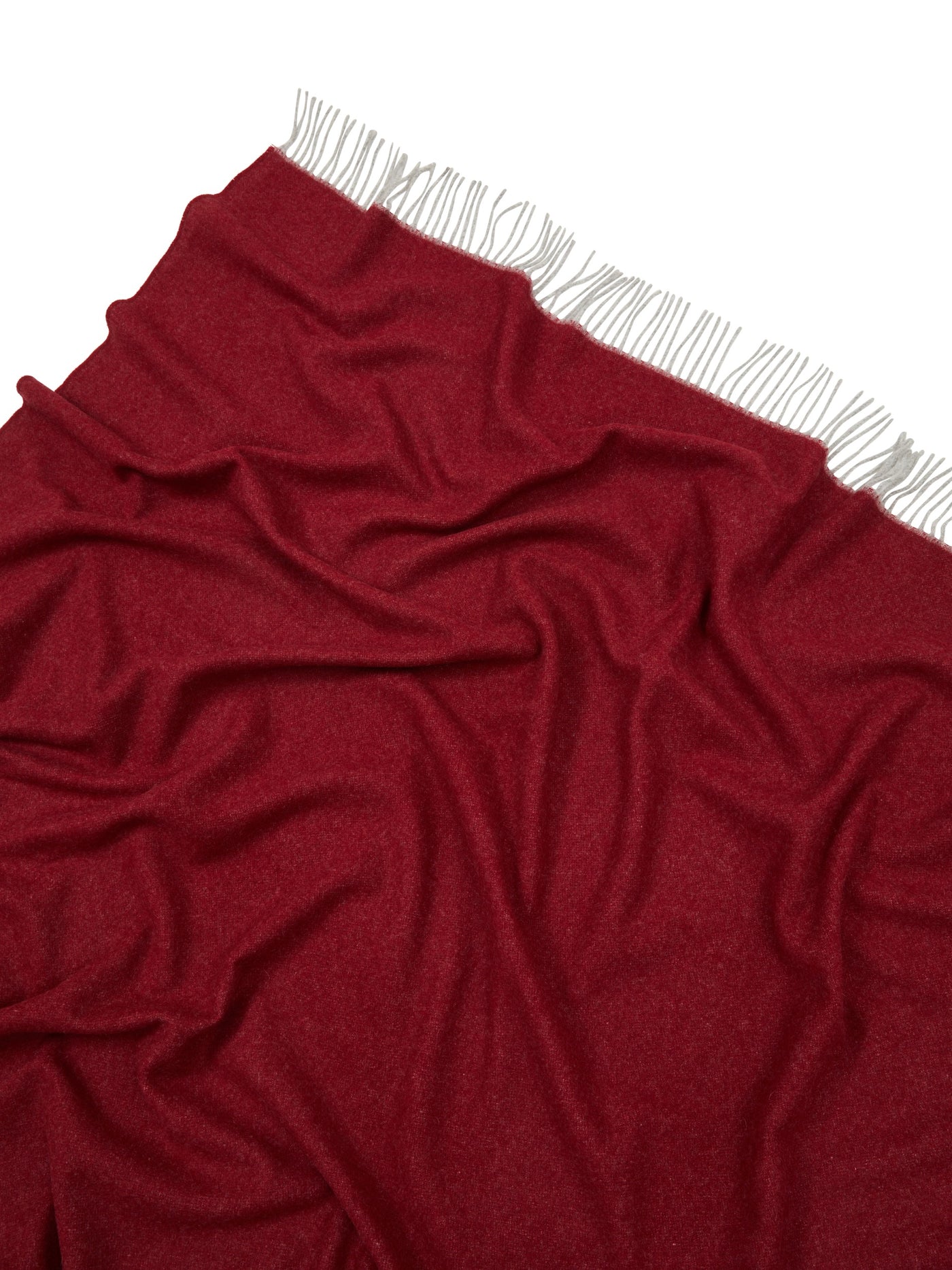 Crimson Lanerossi Ulisse throw draped to show fringe trim detail along top edge.