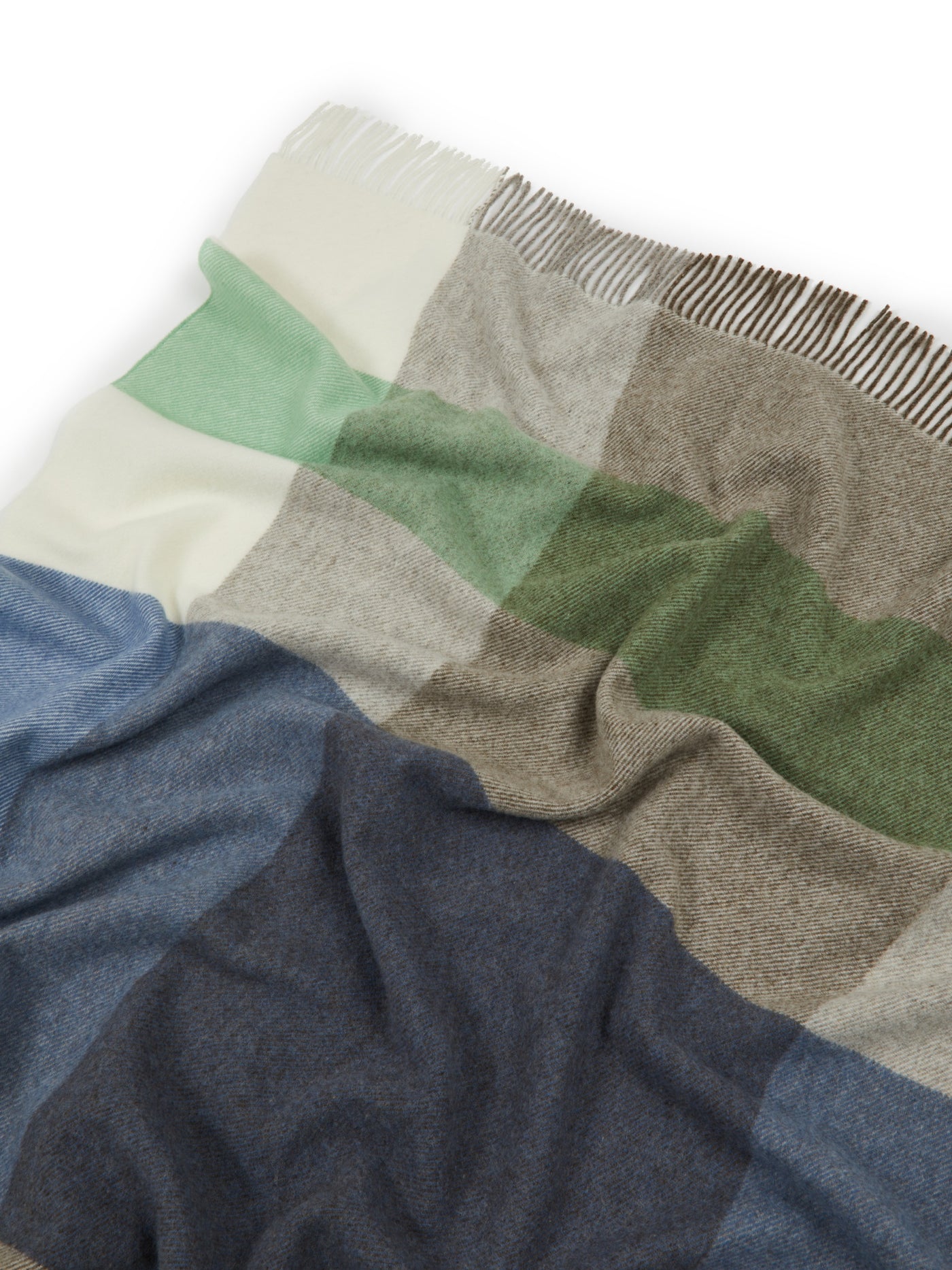Close-up of Lanerossi Uruguay throw with navy, sage, stone, and ivory block checks and fringe trim.