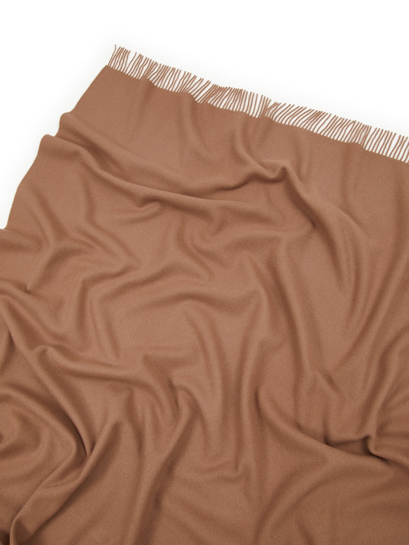 Close-up of Lanerossi Uruguay throw in camel, showing fringe trim edge and draped fabric texture.
