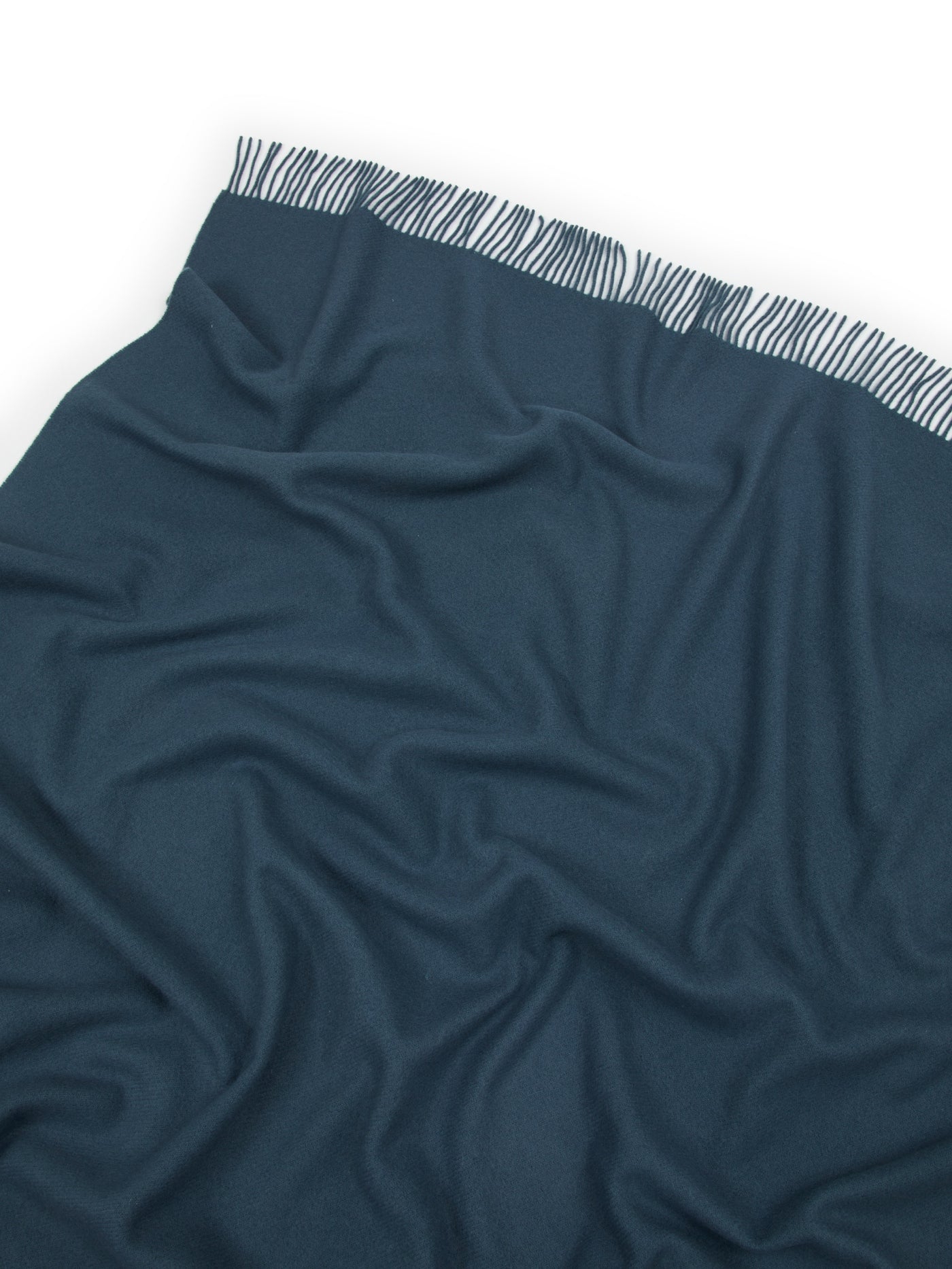 Close-up of Lanerossi Uruguay throw in teal, showing zebra-print trim detail along folded edge.
