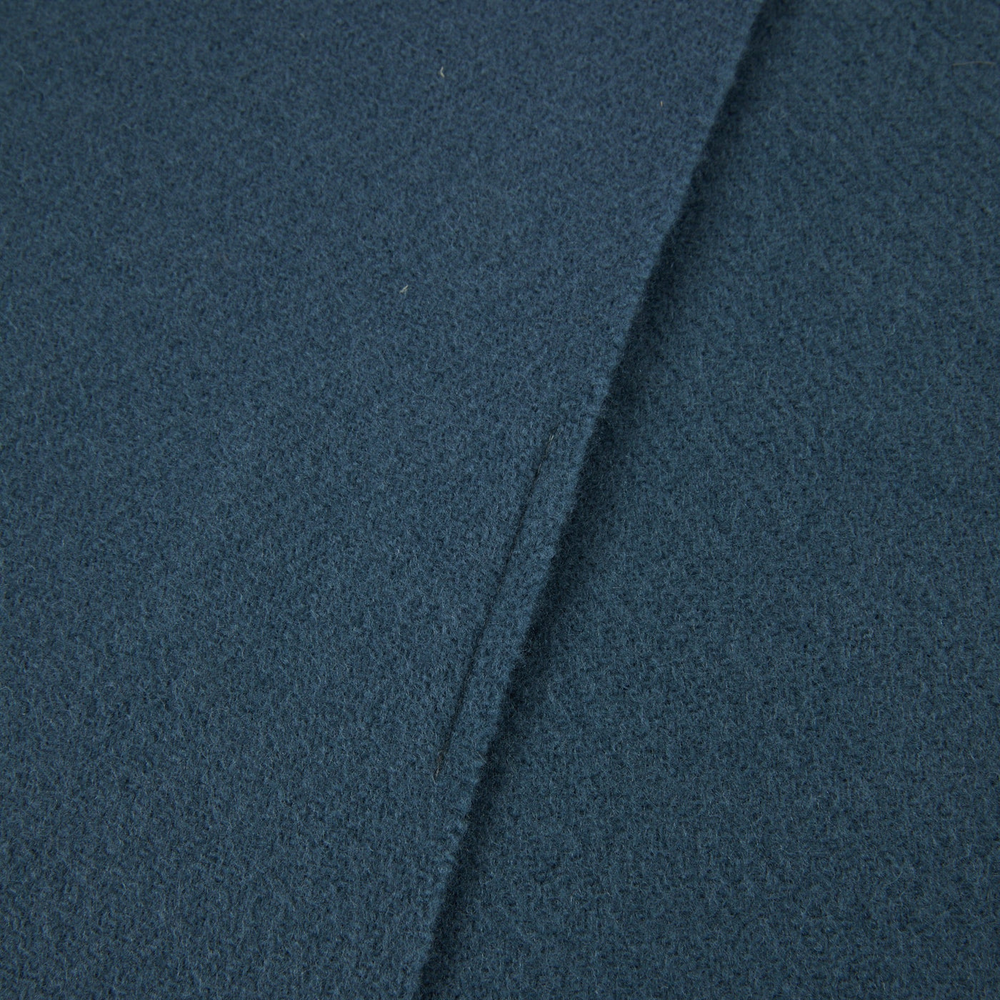 Close-up of Lanerossi Uruguay throw in teal, showing folded edge and boiled wool texture.