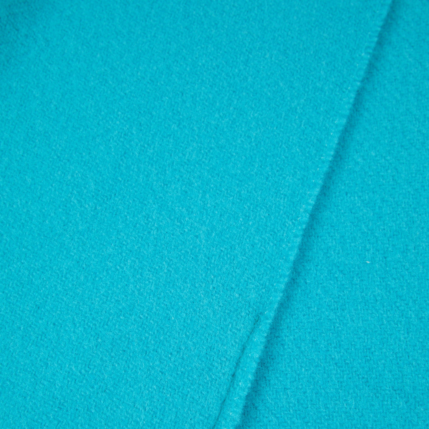 Lanerossi Uruguay throw in turquoise, close-up showing folded edge and wool texture.