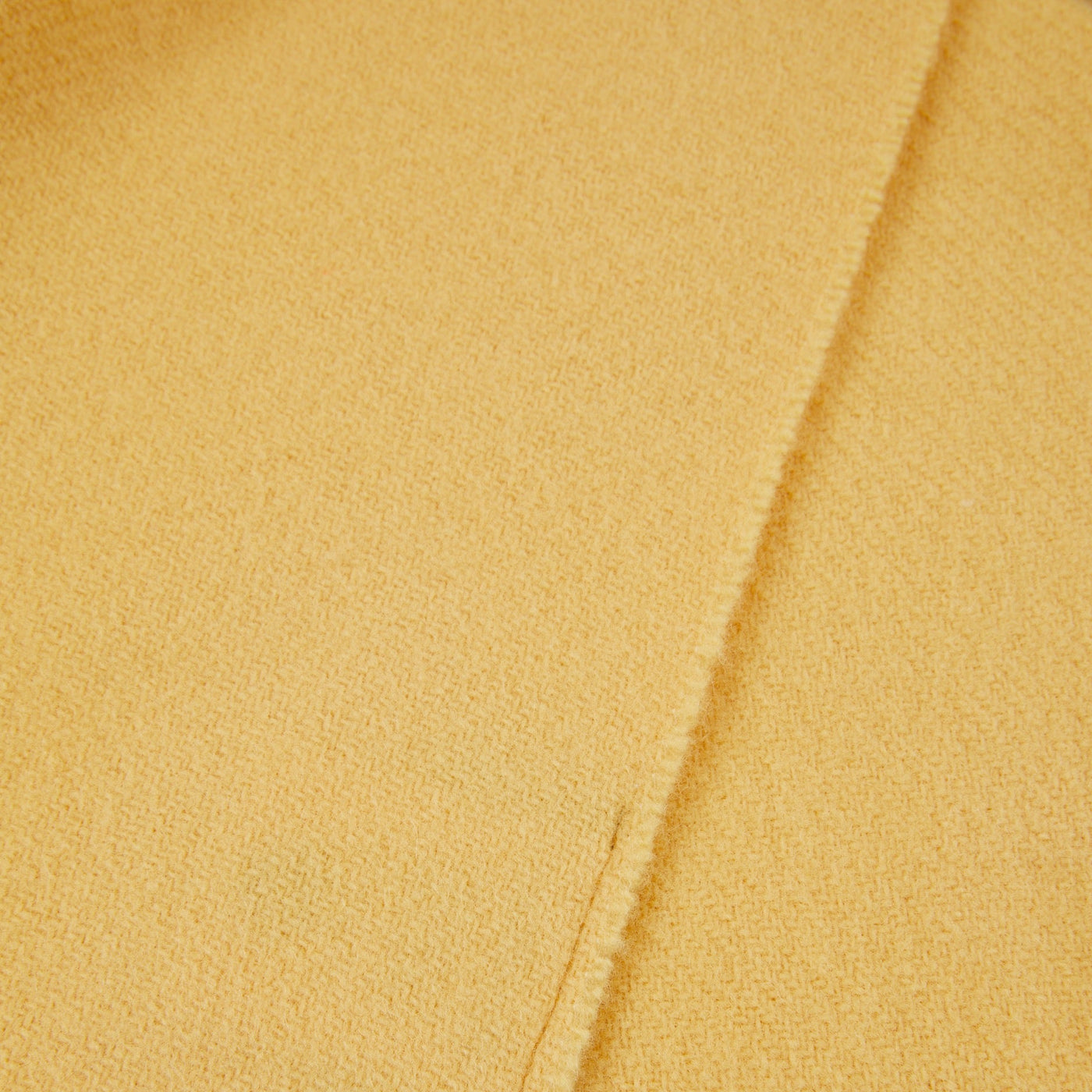 Close-up of Lanerossi Uruguay throw hem in golden yellow, showing woven texture and edge detail.