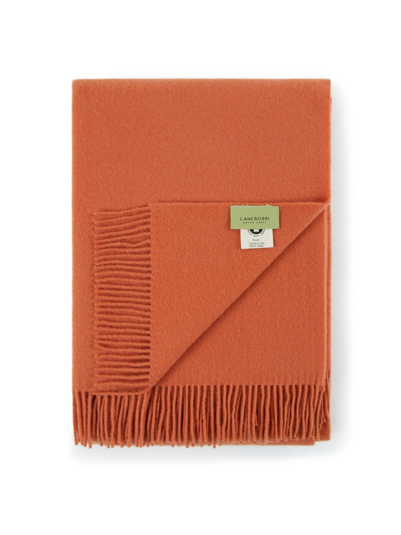 Close-up of folded terracotta Lanerossi Uruguay throw with fringe trim and branded label.