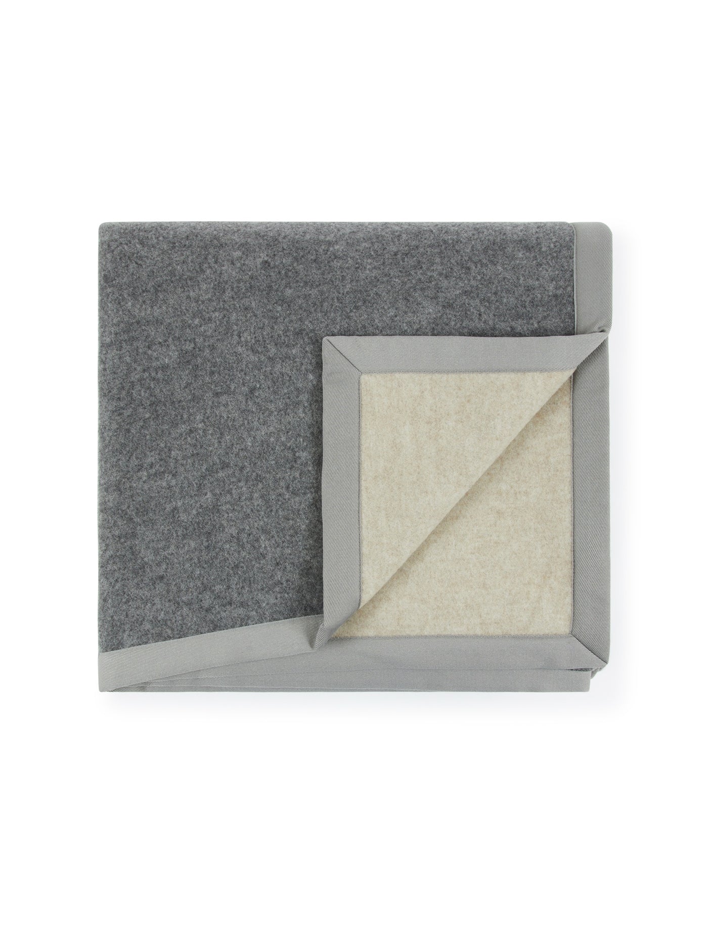 Folded grey wool blanket with ivory interior and grey satin trim, corner turned back.