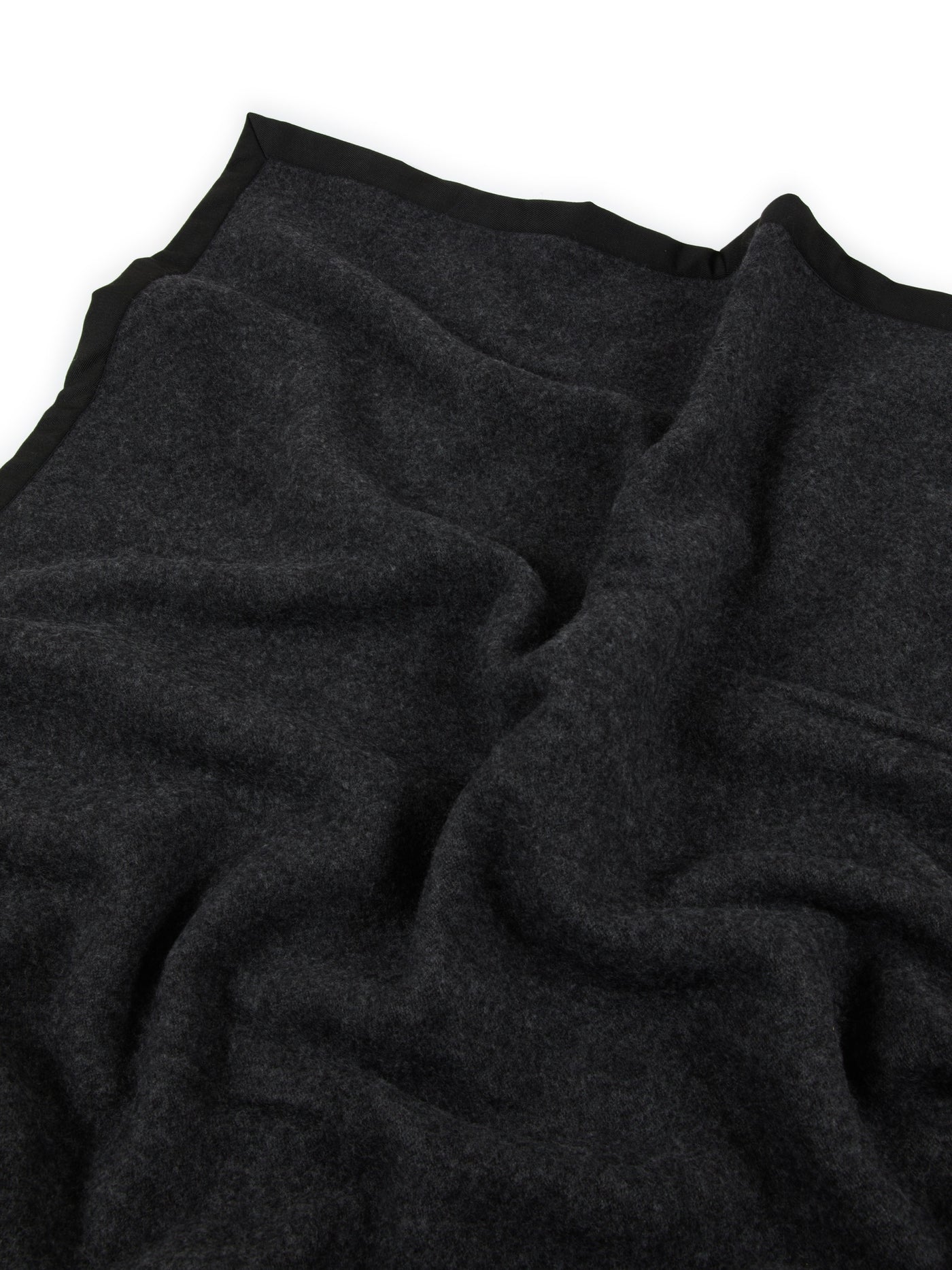 Close-up of Lanerossi Uruguay blanket in charcoal with black blanket-stitched border trim.