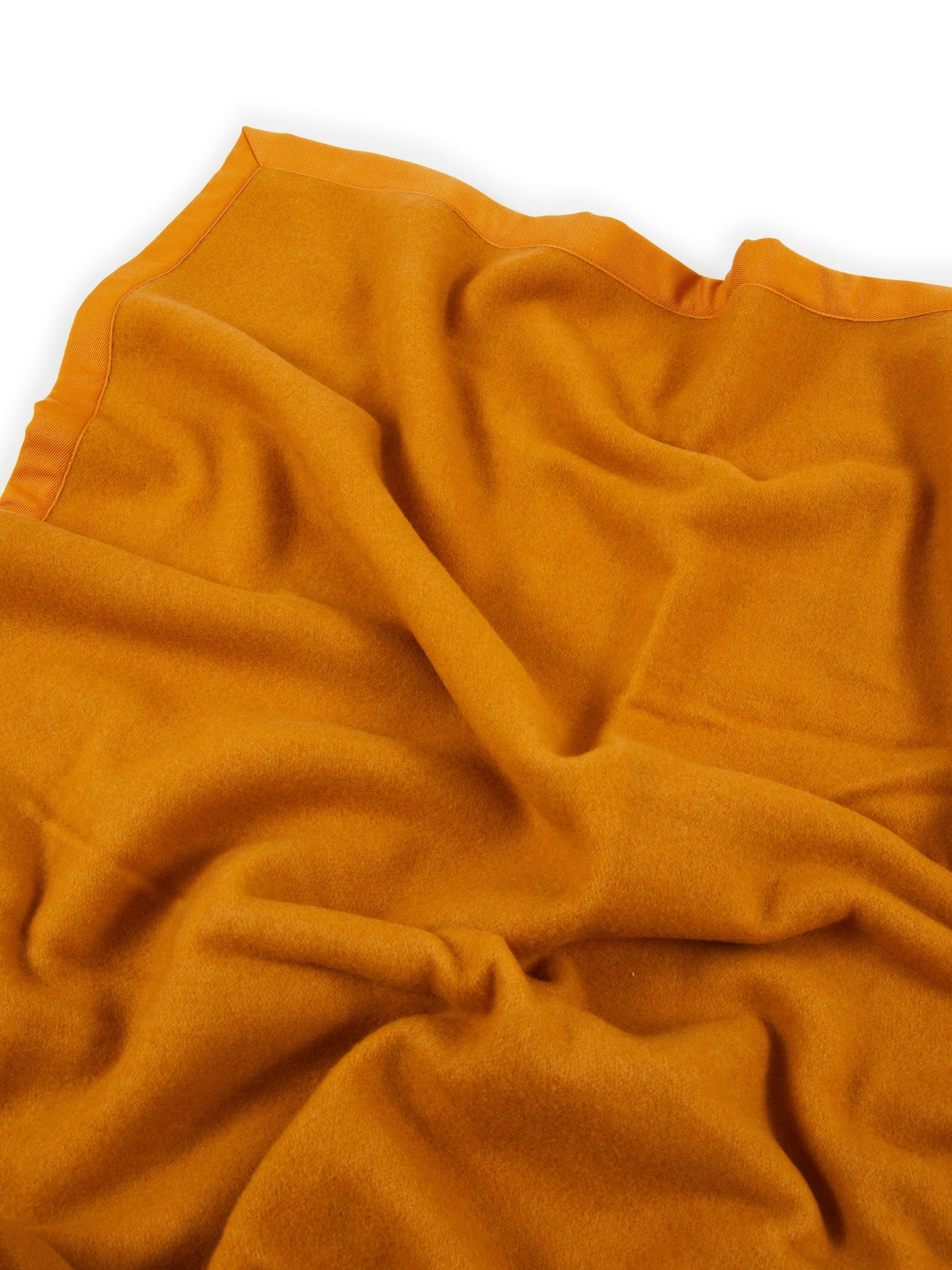 Lanerossi Uruguay blanket in saffron, draped to show satin-trimmed edge and soft wool texture.