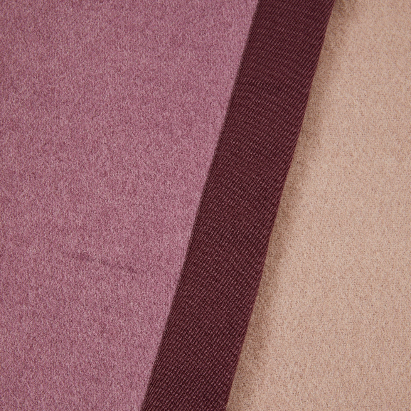Close-up of Lanerossi Uruguay blanket showing dusty rose and taupe wool with burgundy ribbon trim.