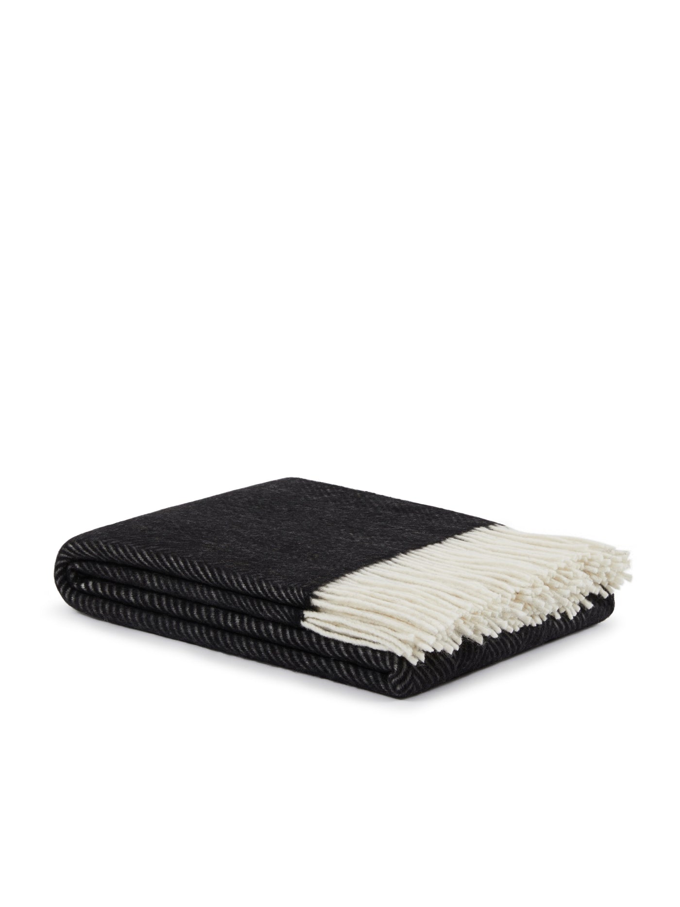 Folded black herringbone wool throw with ivory fringe detail, angled view.
