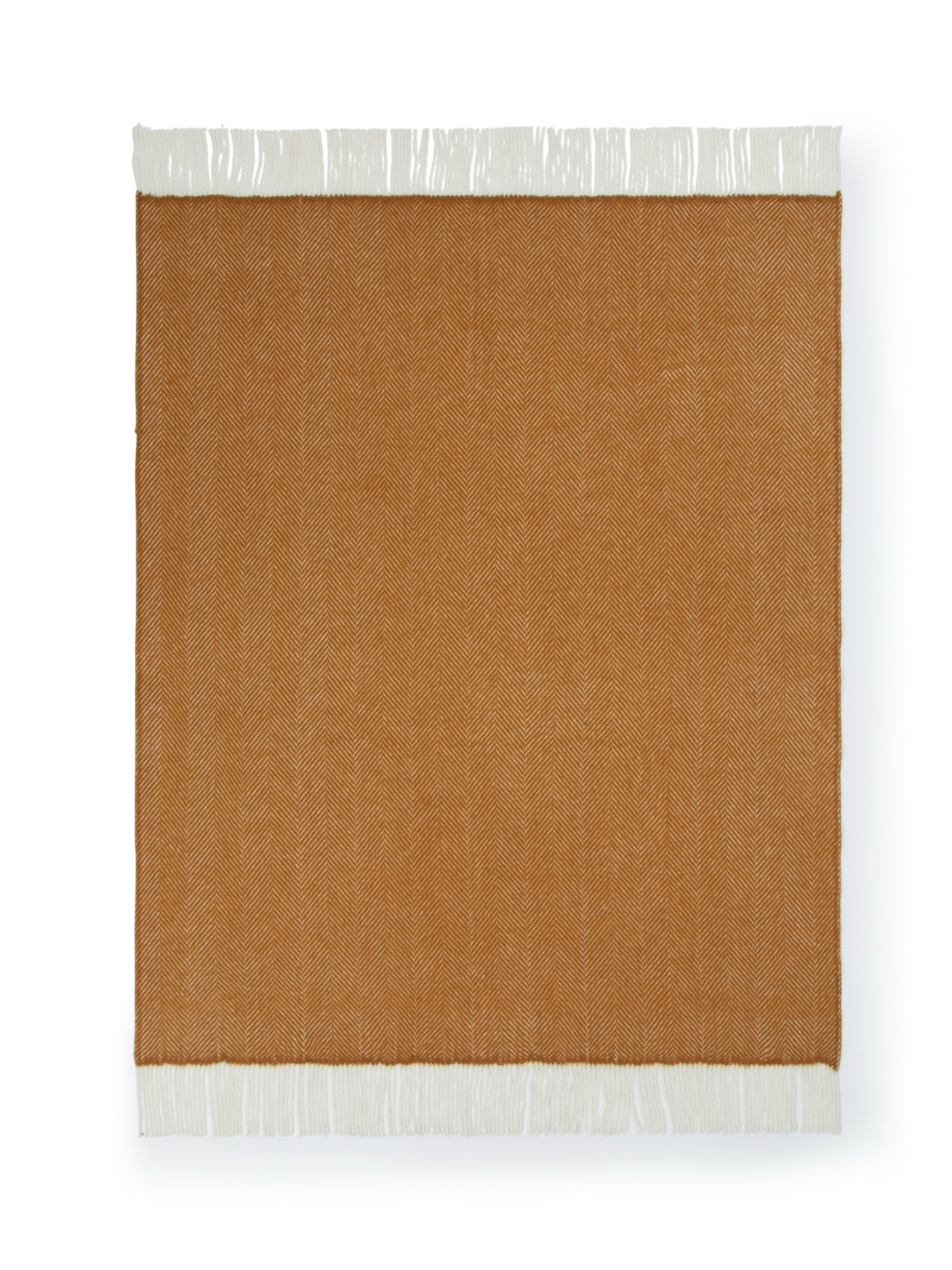 Close-up of Uruguay GOTS Maxi throw in amber with ivory fringe trim detail.