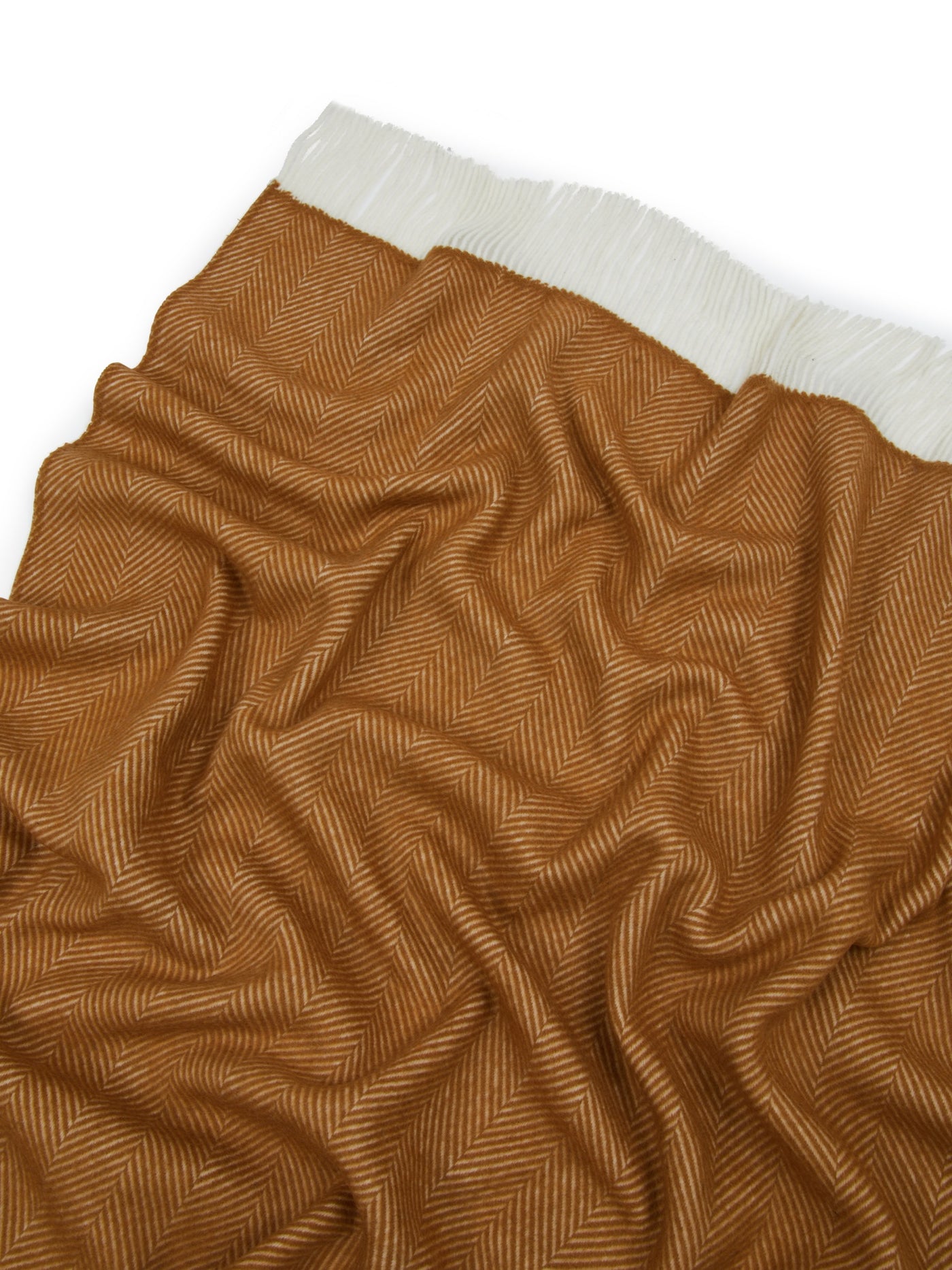 Close-up of Lanerossi Uruguay throw in amber herringbone weave with ivory fringe trim.
