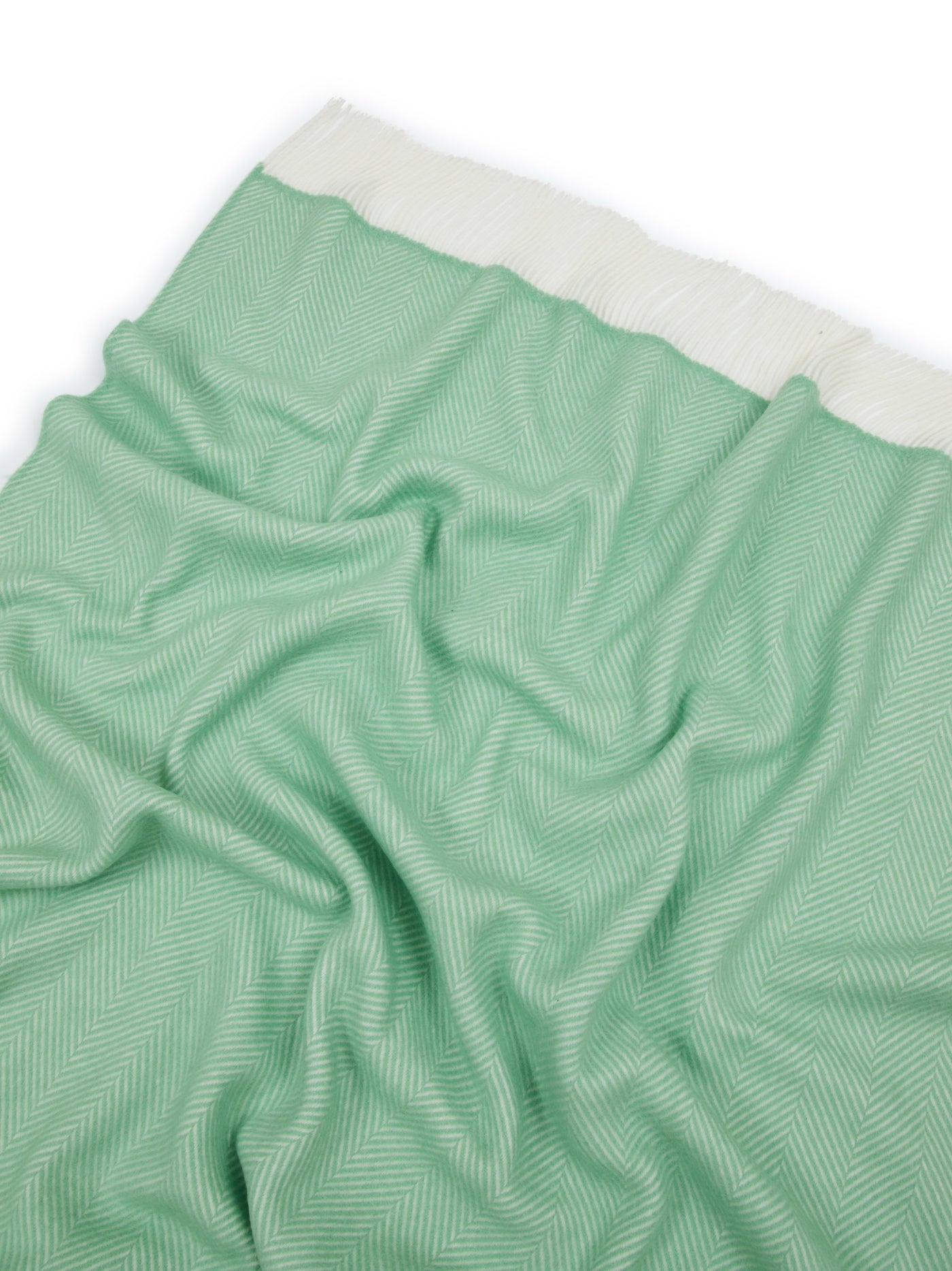 Close-up of Lanerossi Uruguay throw in mint, showing herringbone weave and ivory fringe border.