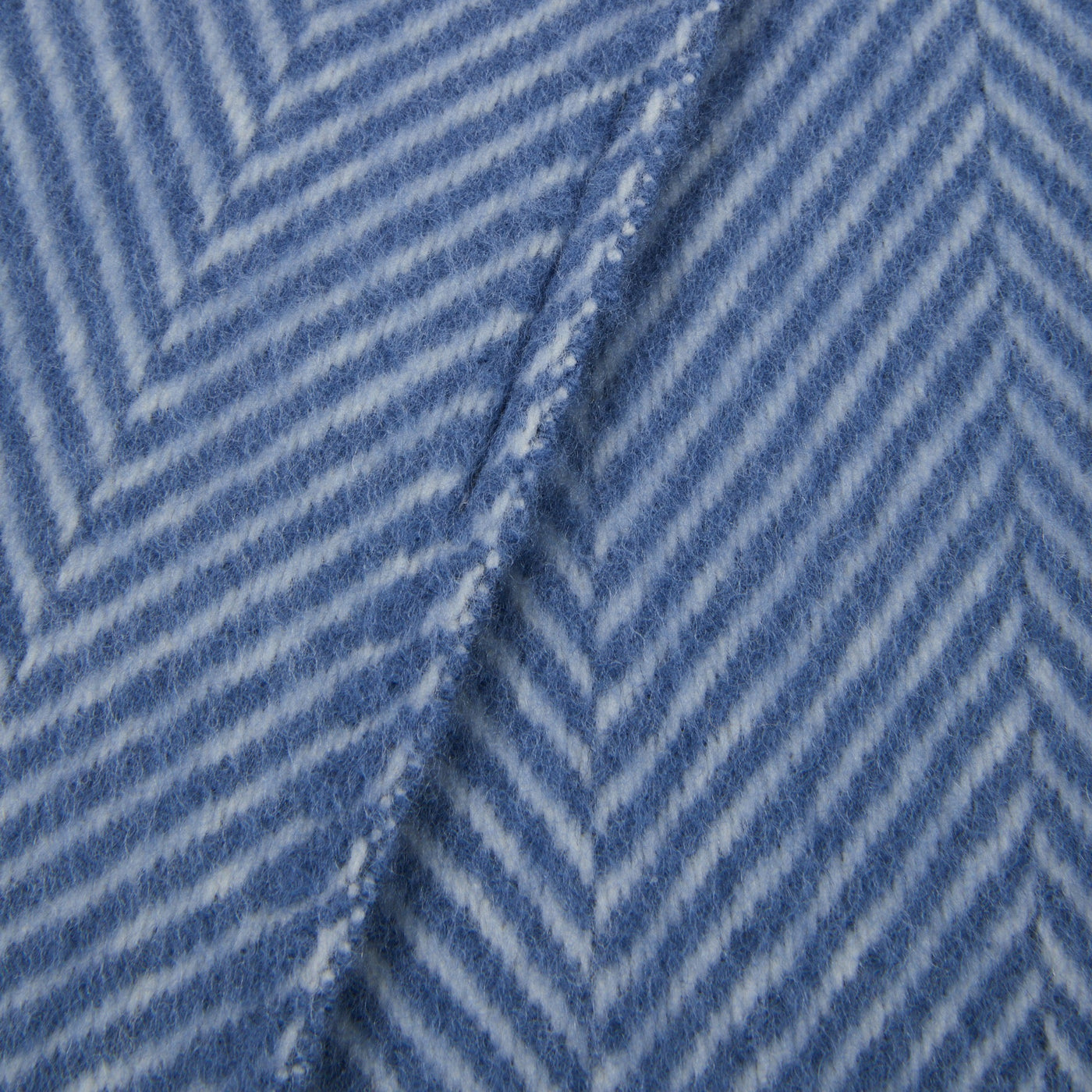 Close-up of Lanerossi Uruguay throw in blue, showing herringbone weave texture and fringed edge.