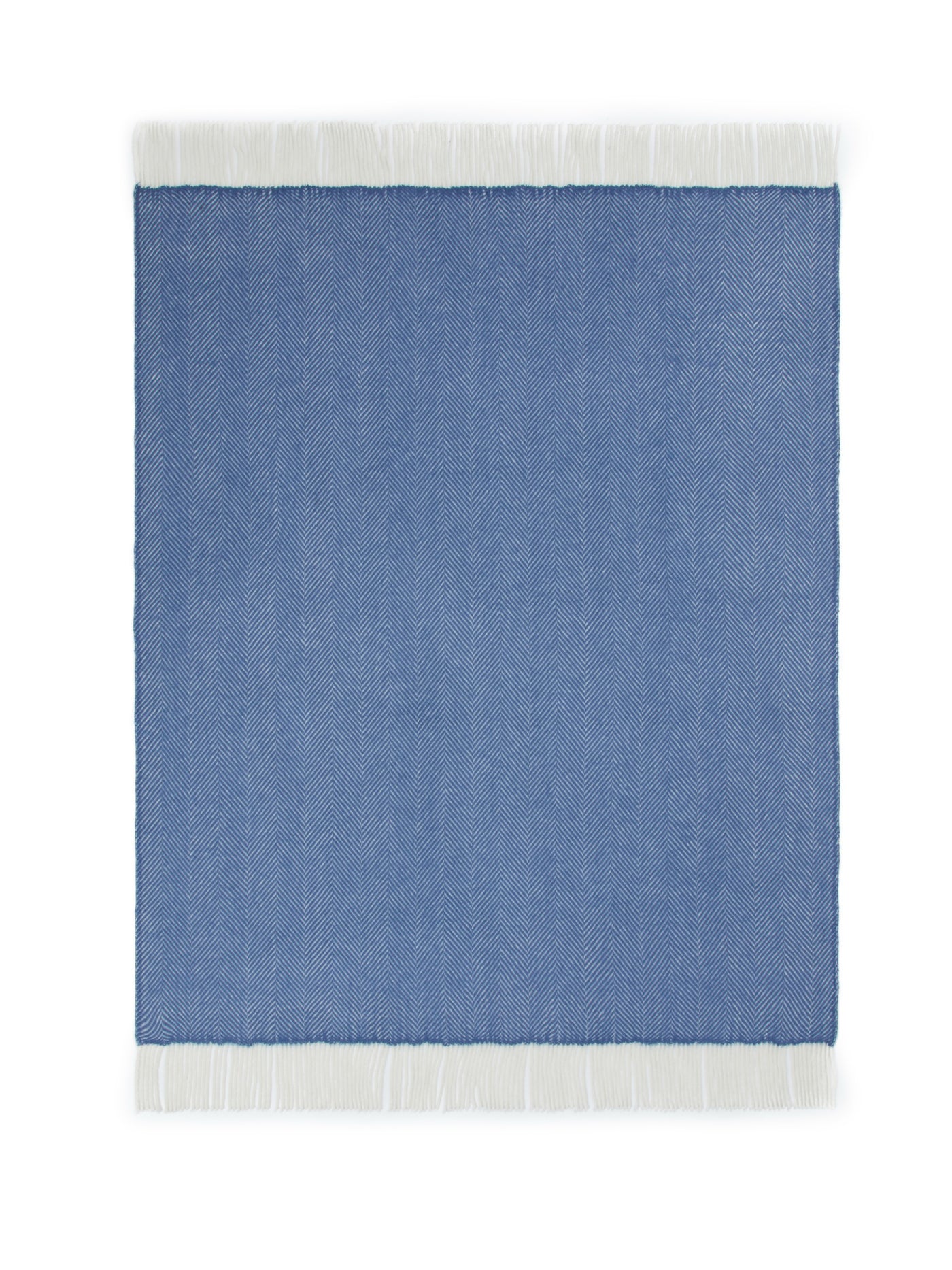 Cornflower blue herringbone weave throw with white fringe trim, flat lay view.