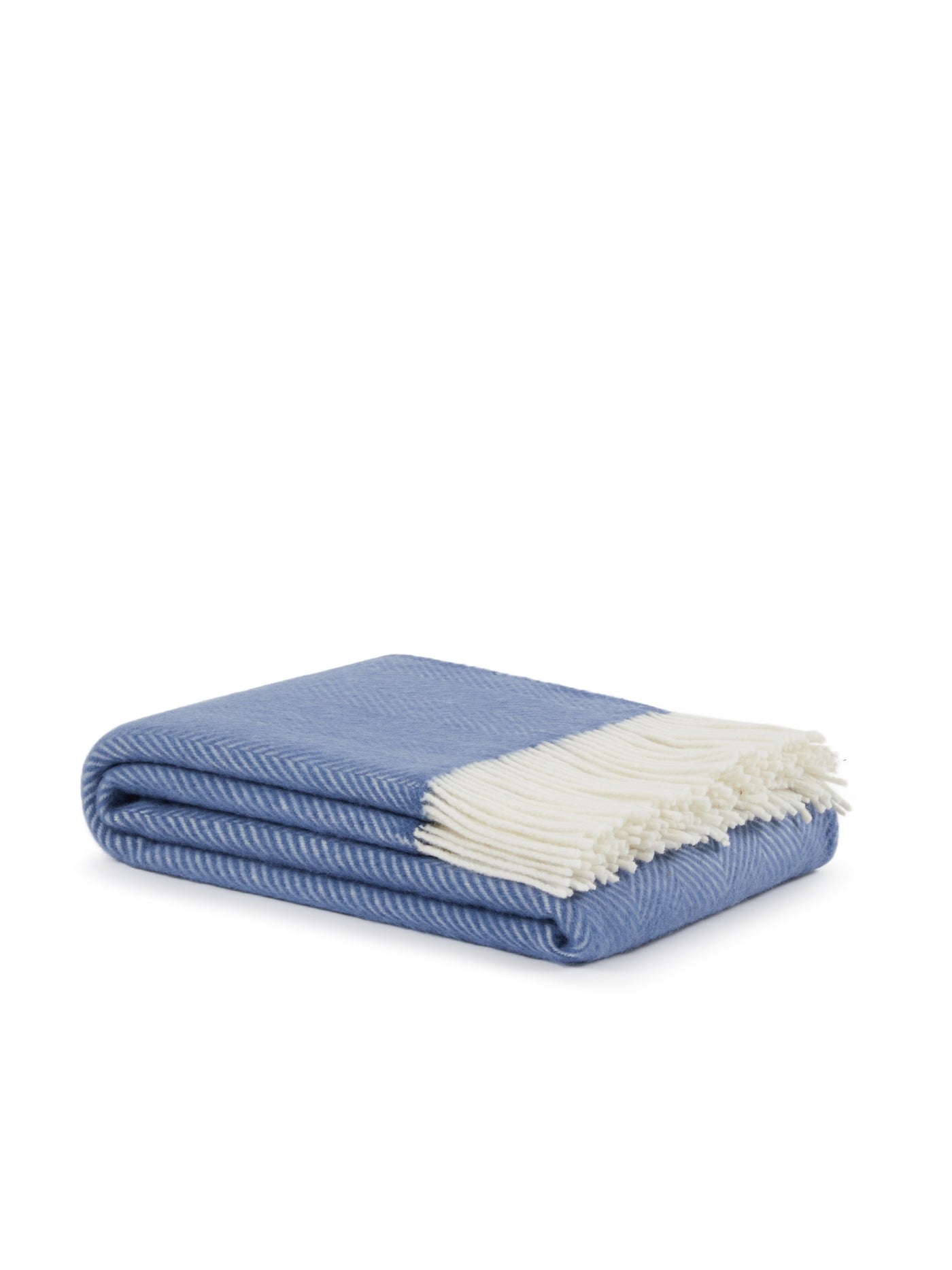 Cornflower blue herringbone throw folded to show ivory fringe detail.