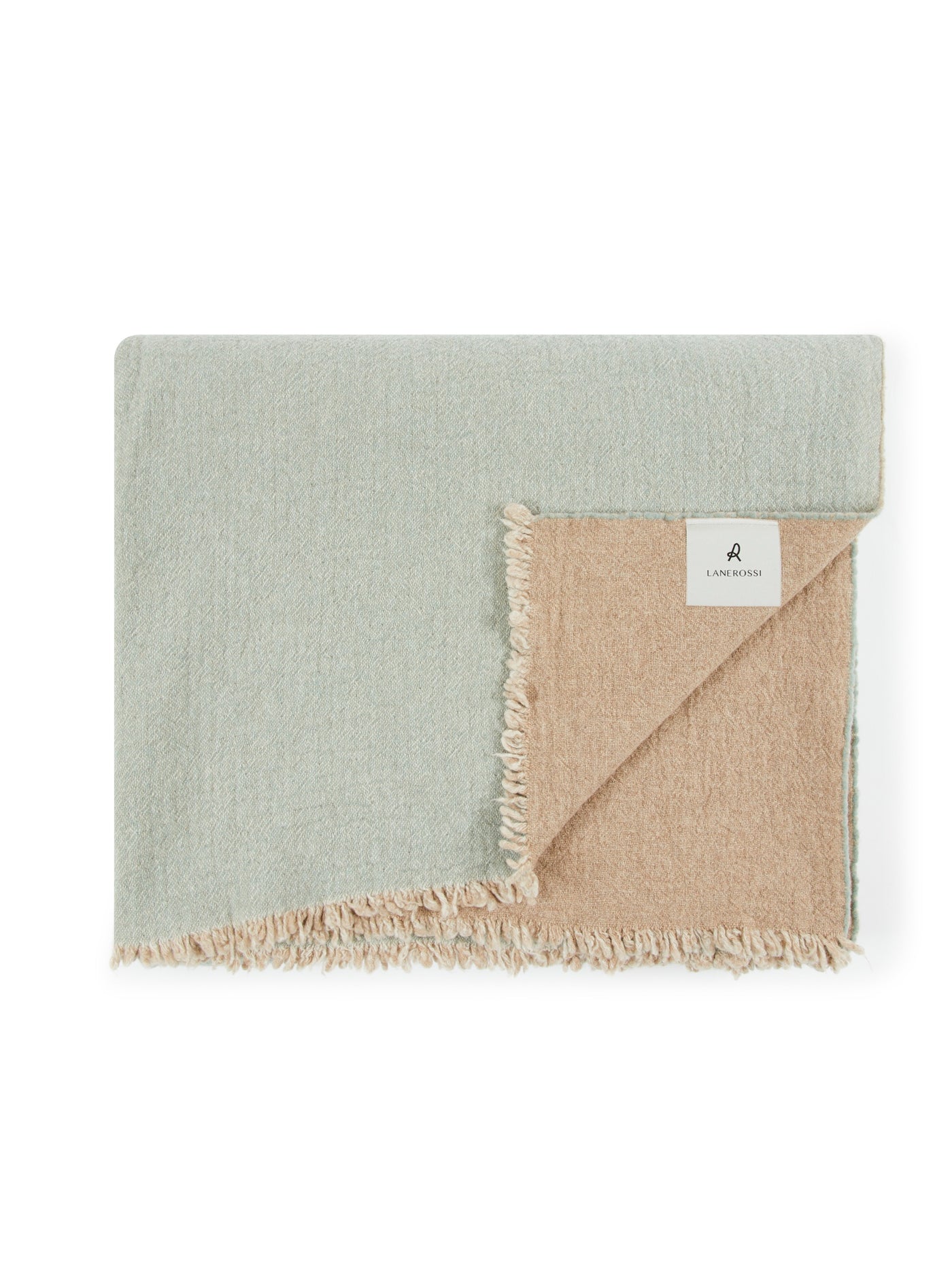 Sage and sand reversible blanket folded to reveal contrast side and fringe trim.