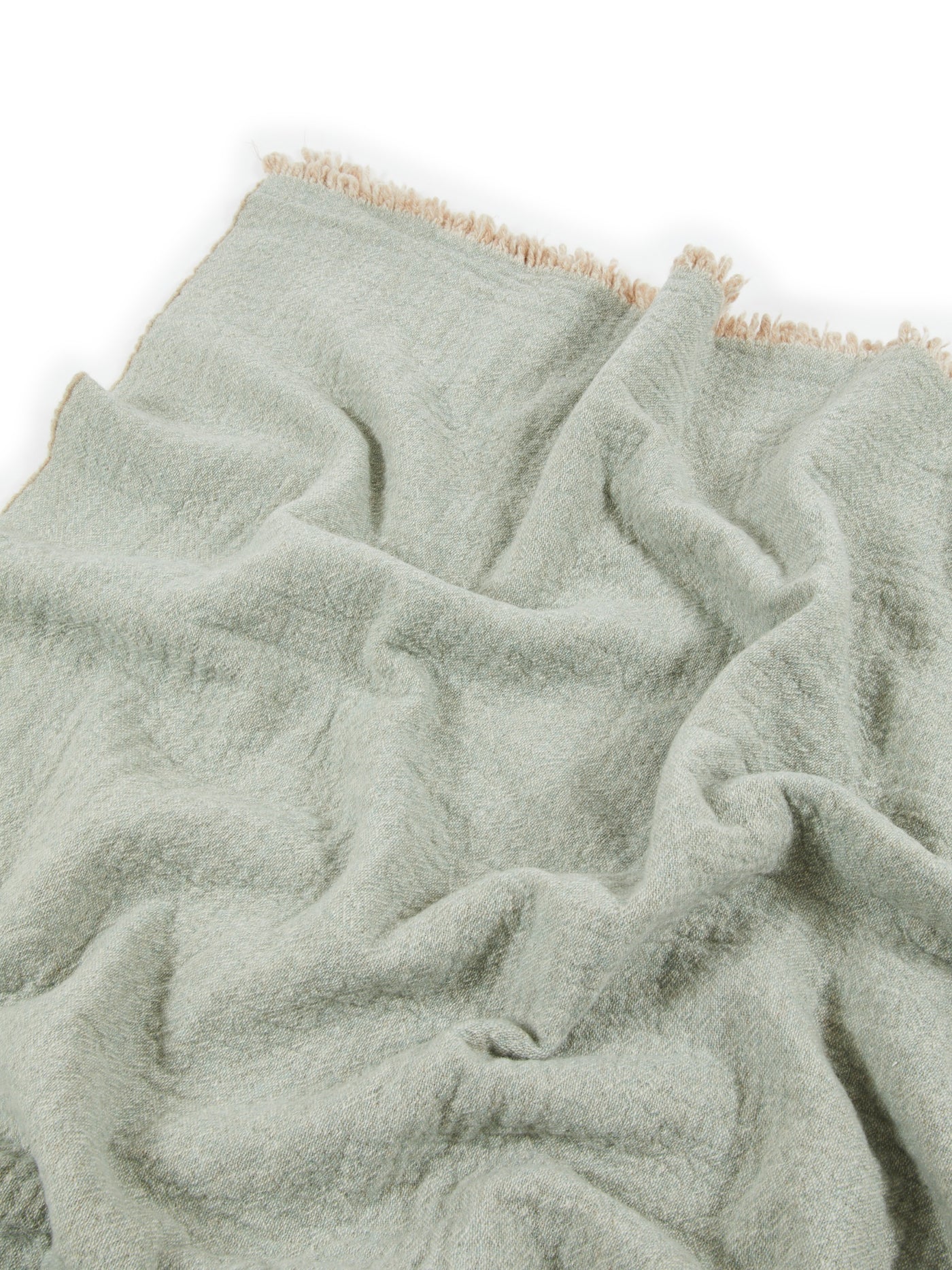 Close-up of Lanerossi Venere blanket in sage with cream fringe trim detail.
