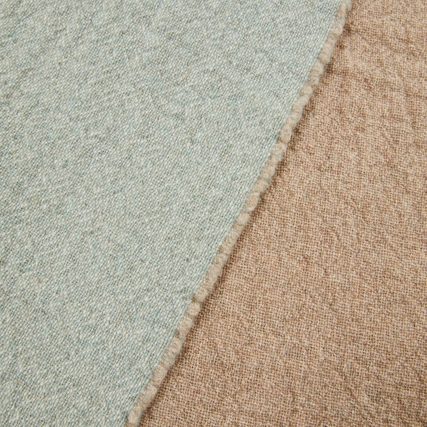 Close-up of Lanerossi Venere blanket reversible edge, sage and camel wool blend sides.