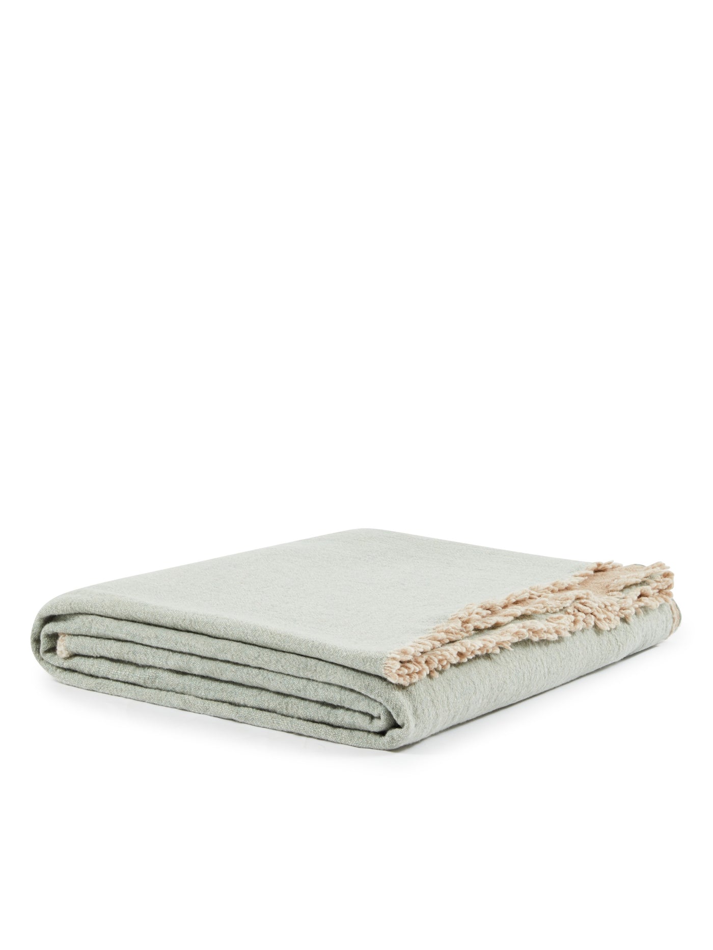 Folded sage green blanket with contrast natural fringe trim detail.