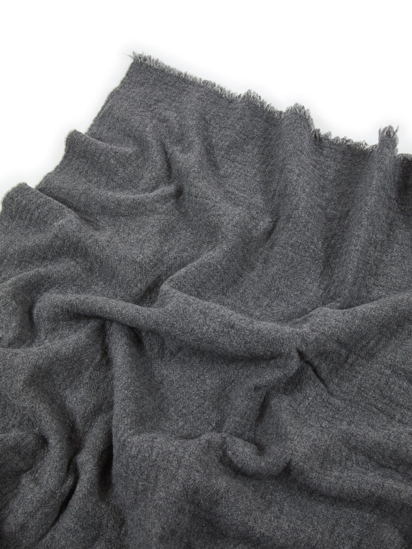 Charcoal wool blanket close-up showing soft drape and fringe edge detail.