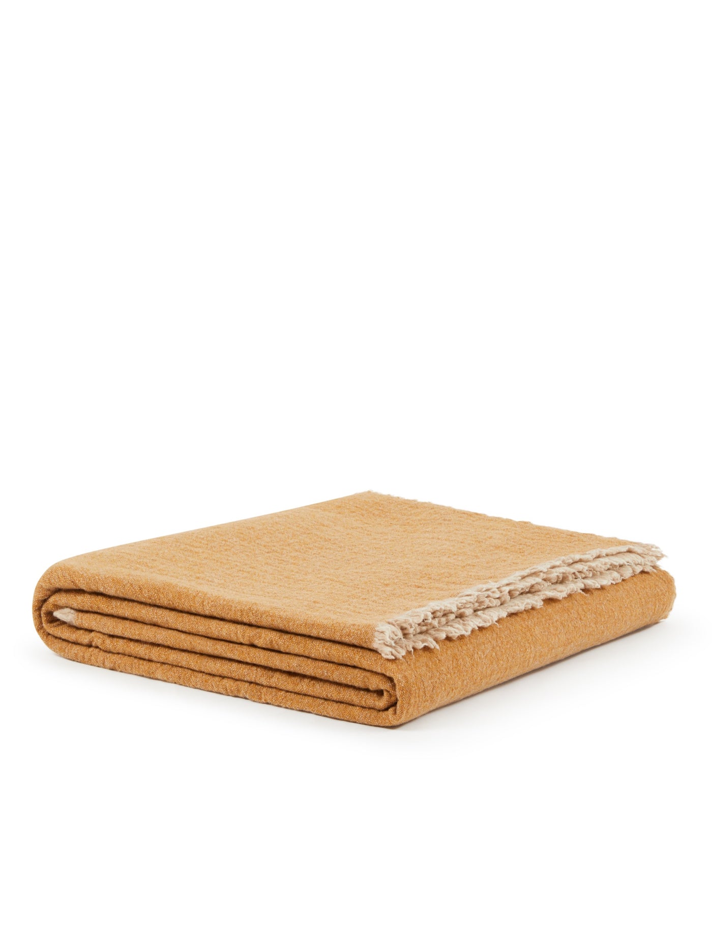 Lanerossi Venere blanket folded, showing amber textured weave with natural fringe trim.