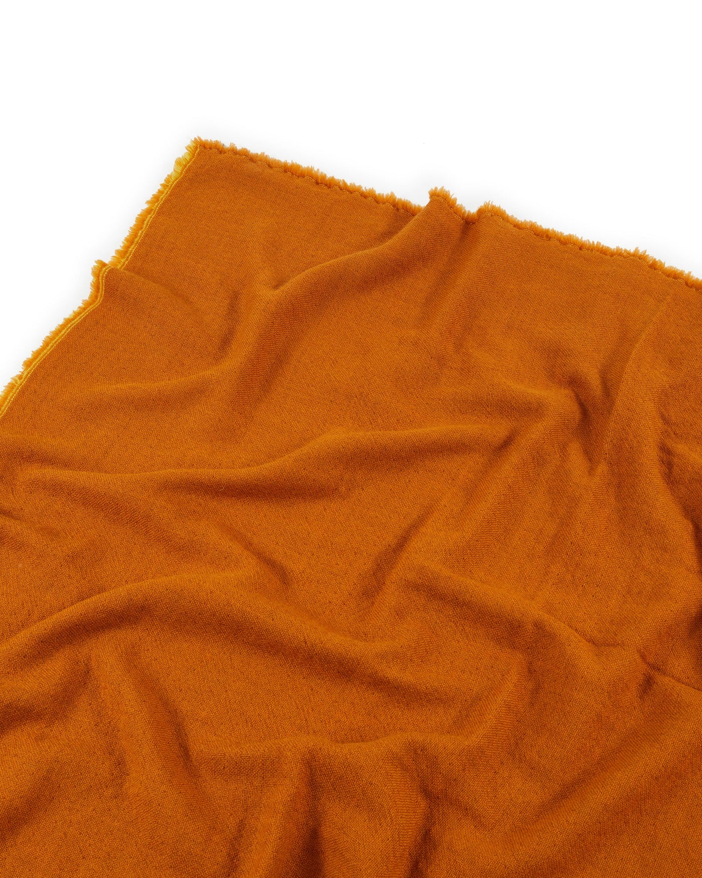 Lanerossi Zebio blanket in amber, soft bouclé texture with fringed edges, draped flat.