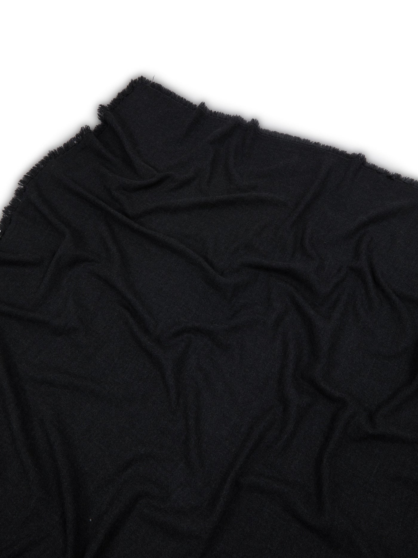 Lanerossi Zebio throw in black, draped to show soft knit texture and frayed edges.