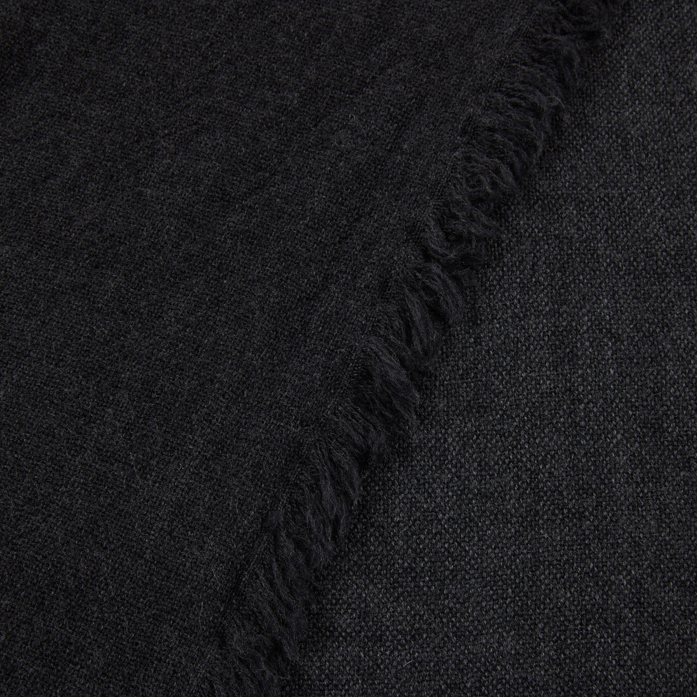 Close-up of Lanerossi Zebio throw's fringed edge in charcoal woven fabric.