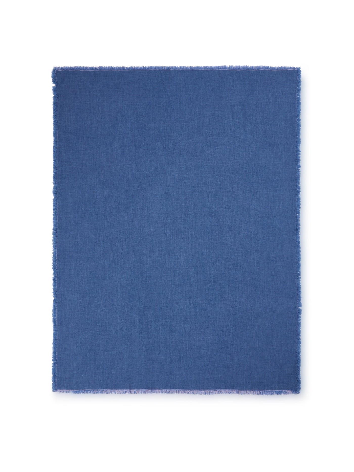 Cobalt blue woven throw with fringed edges, flat lay view.