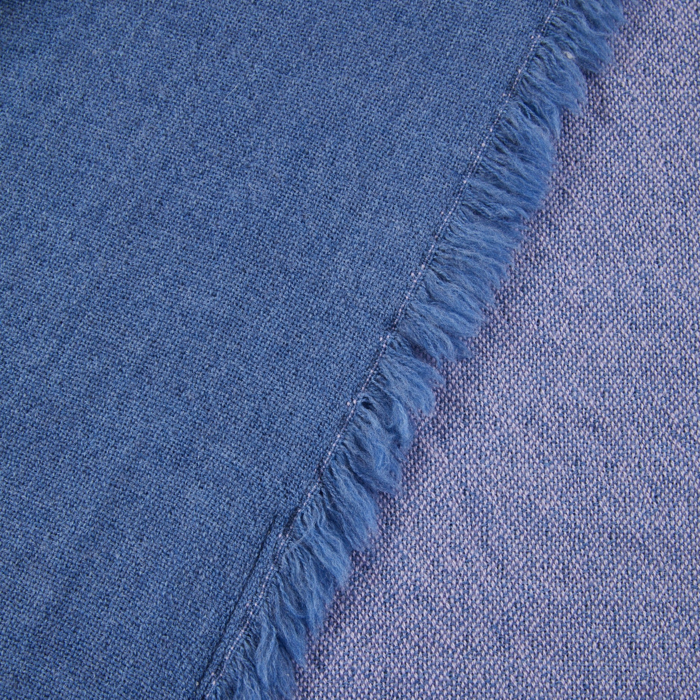 Close-up of Lanerossi Zebio throw's fringe edge in cobalt blue woven fabric.