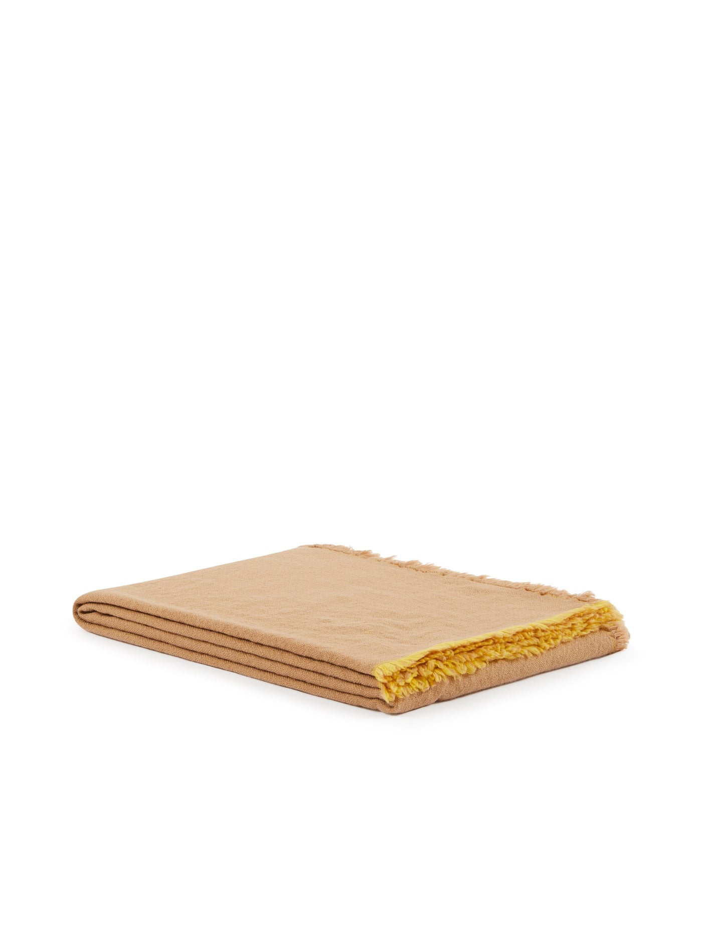 Folded camel throw with contrasting mustard fringe trim detail.