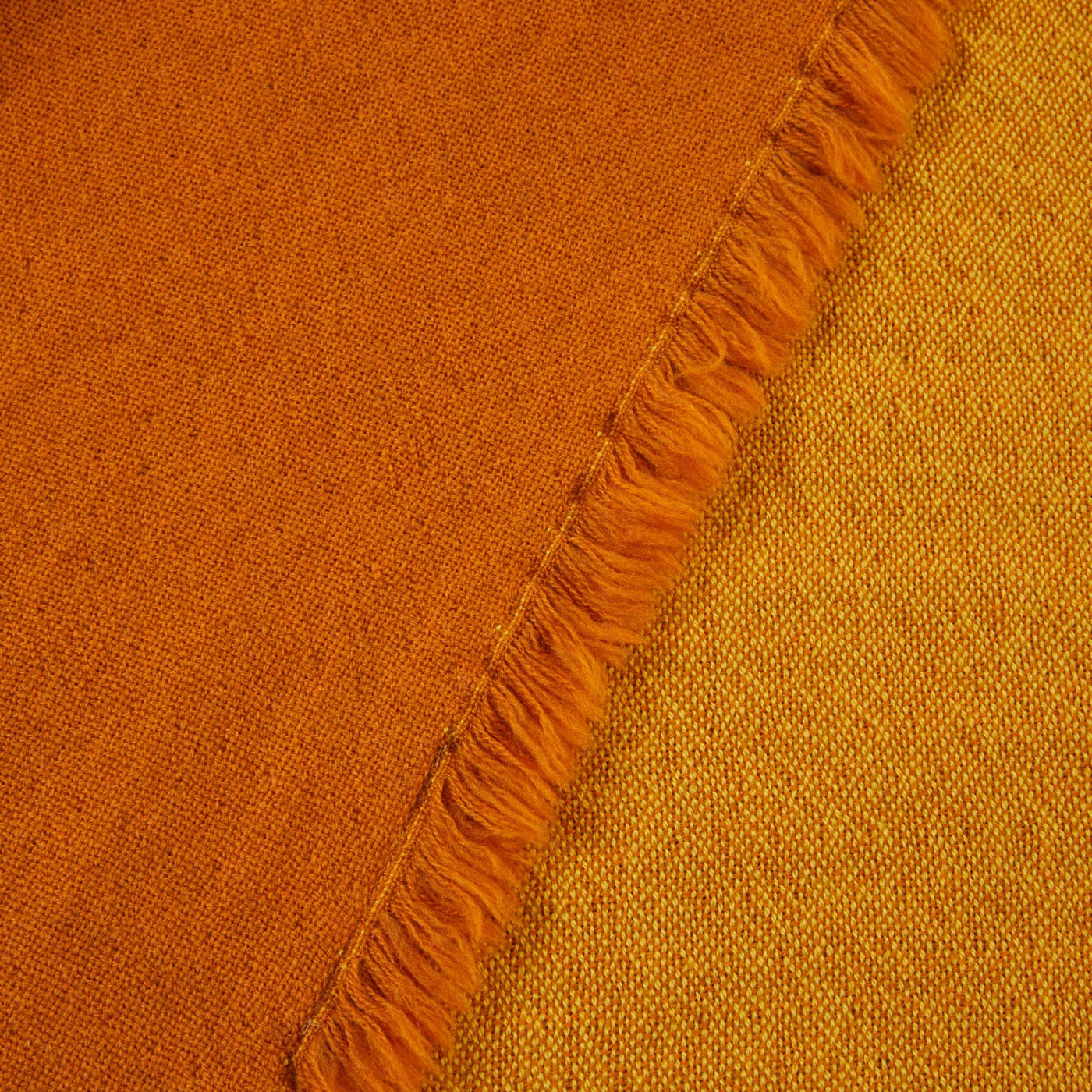 Close-up of Lanerossi Zebio throw fringe edge, showing rust and amber reversible weave.
