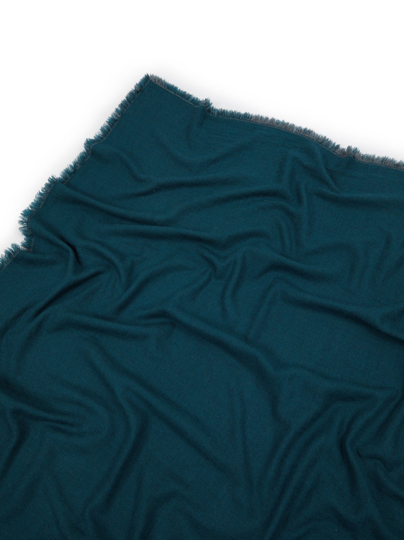 Zebio throw in teal, draped flat showing fringe edge and soft woven texture.