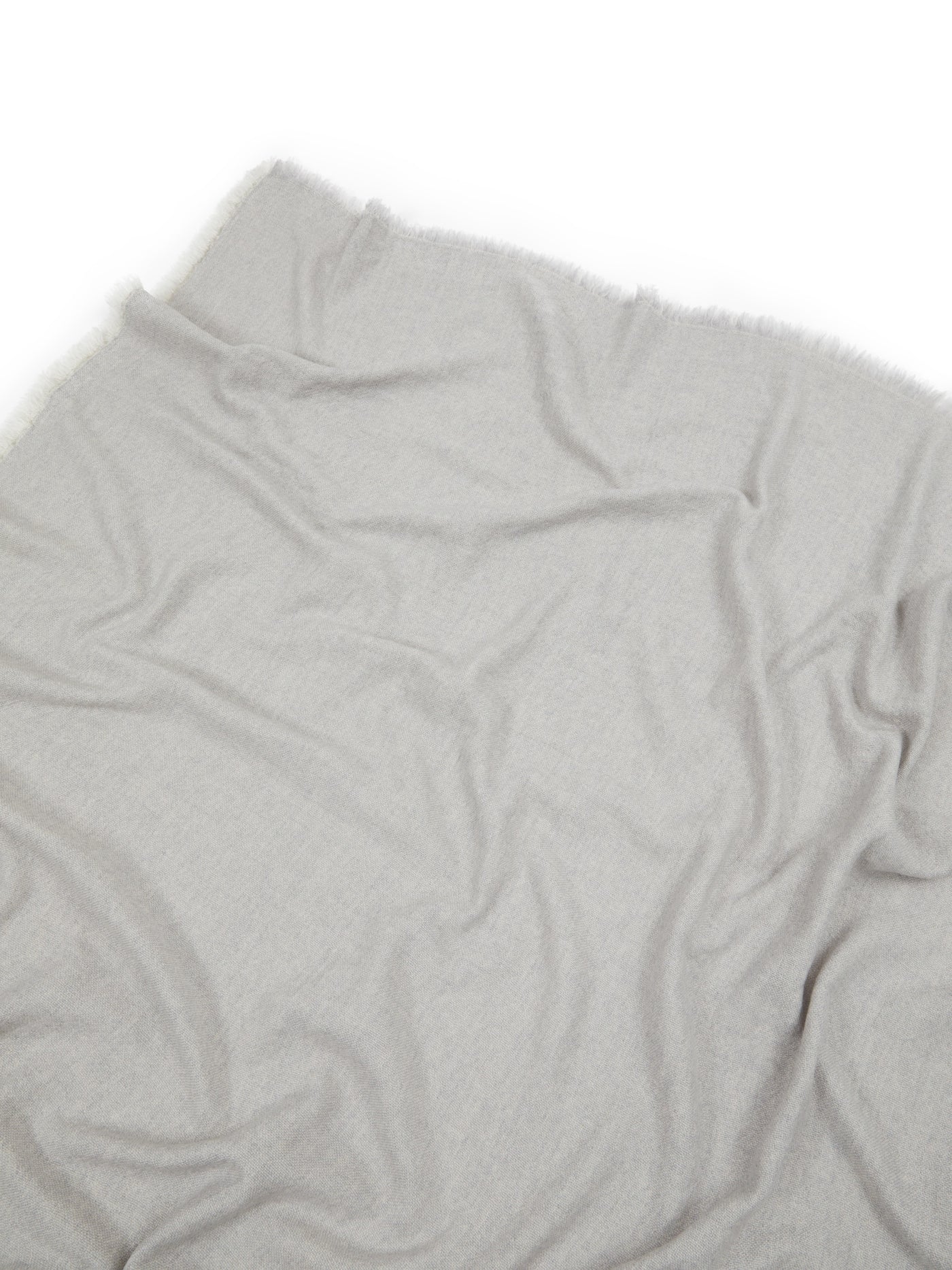 Overhead close-up of Lanerossi Zebio throw in silver-grey, showing soft drape and frayed edges.