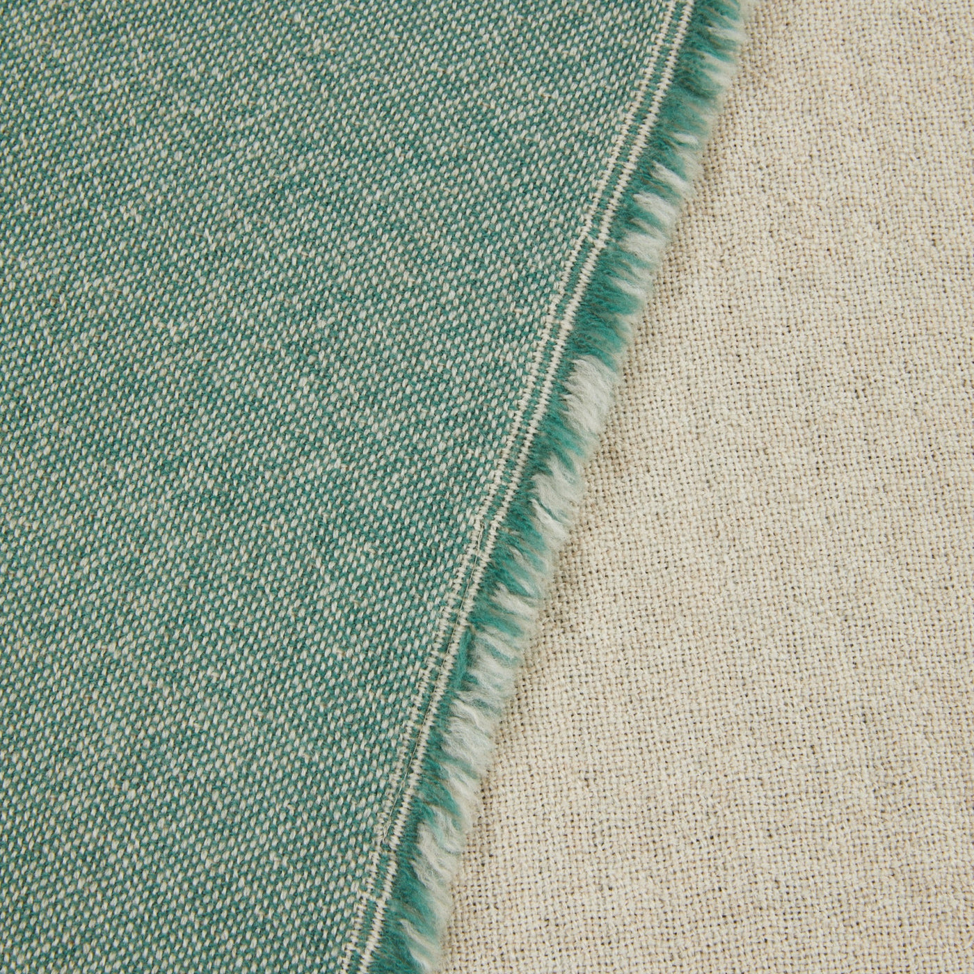 Close-up of Lanerossi Zebio blanket edge showing teal and natural weave with fringe detail.