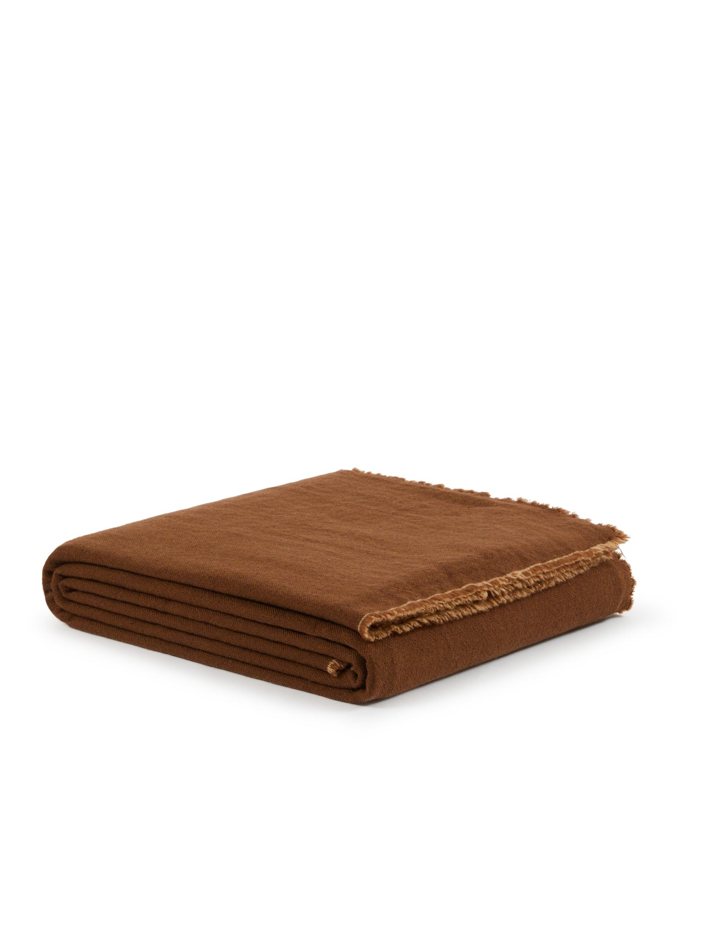 Zebio blanket folded in toffee, showing raw fringe edge detail along one corner.
