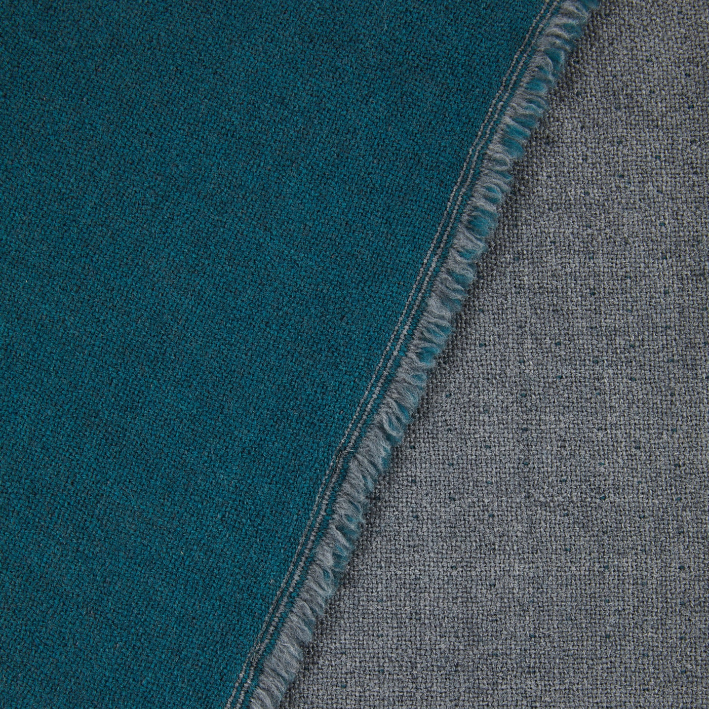 Close-up of Lanerossi Zebio blanket reversible edge, teal and grey wool faces.