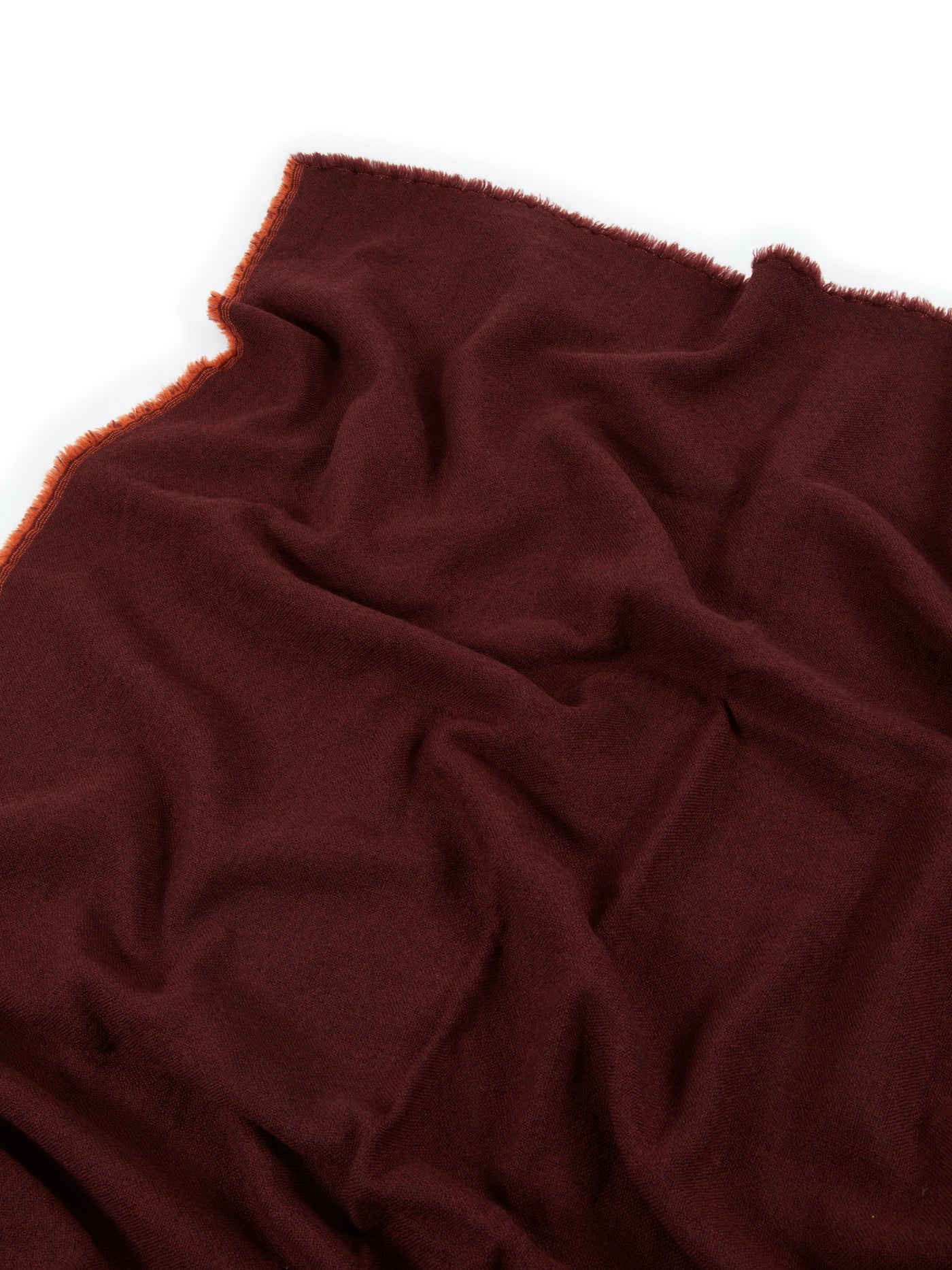 Close-up of Lanerossi Zebio blanket in deep burgundy with fringe edge detail.