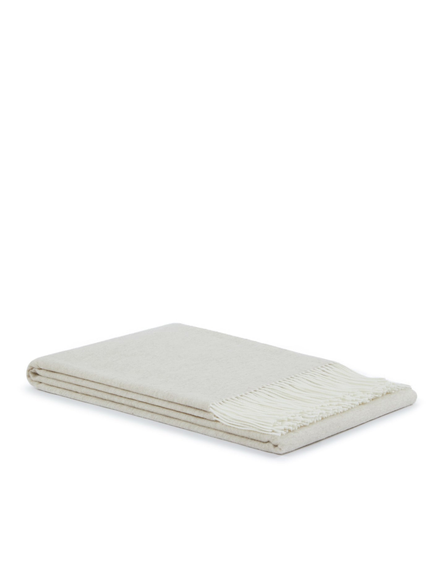 Ivory throw folded flat, showing fringe trim along one edge.