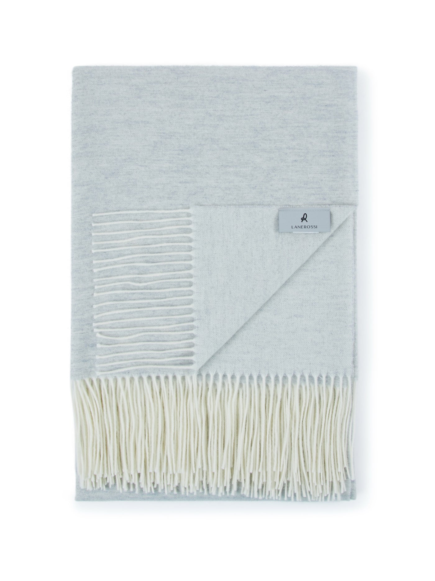 Lanerossi Alashan throw in pale blue, folded to show ivory fringe and contrast reverse.