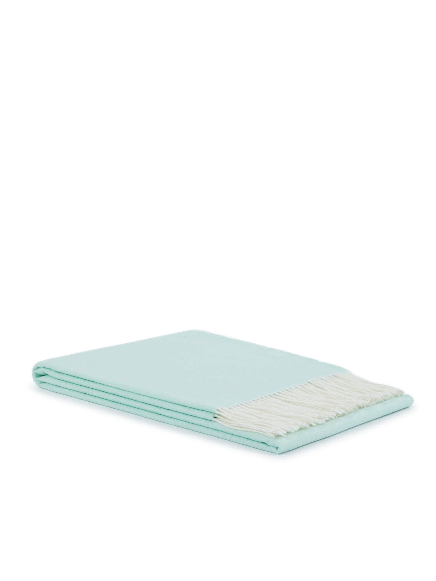 Folded mint throw with ivory fringe trim, angled view showing smooth weave.