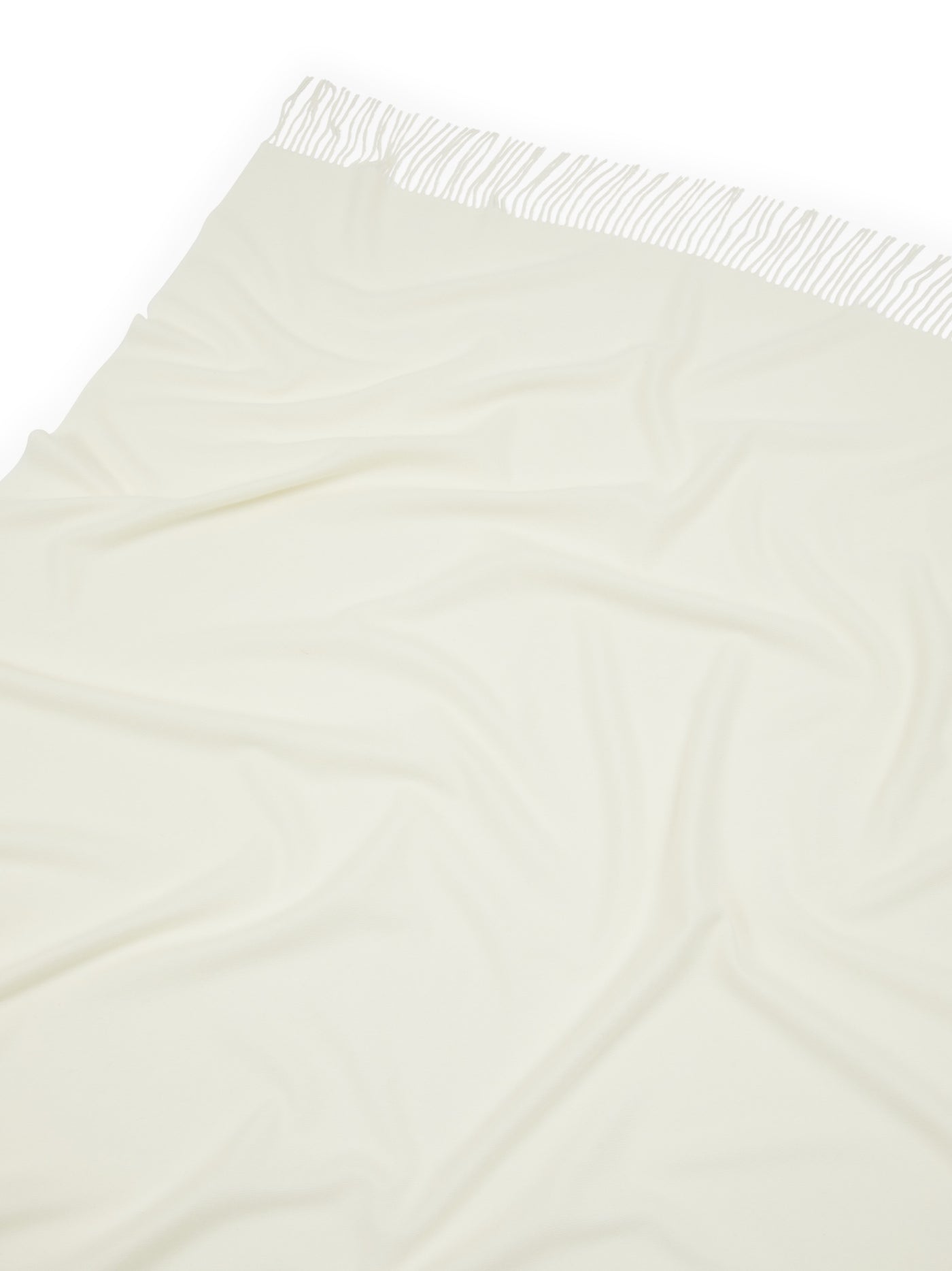 Ivory throw draped flat showing fringe trim detail along one edge.