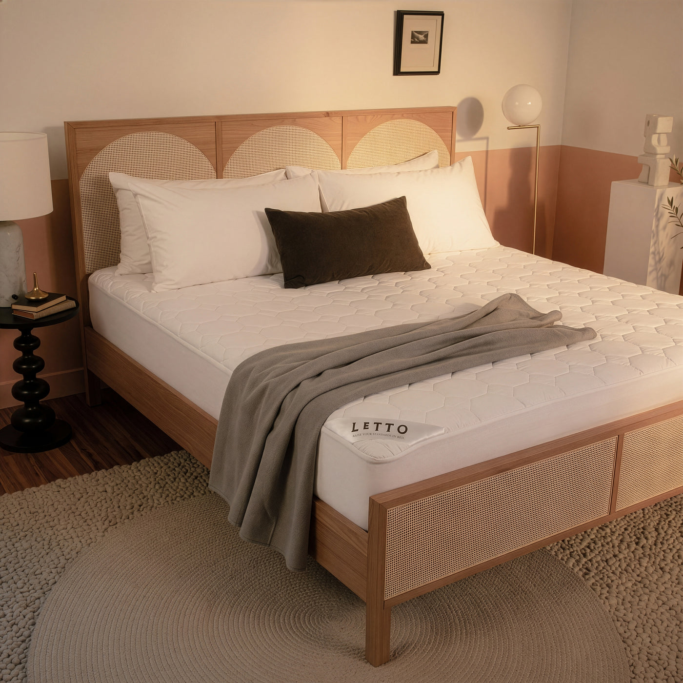 Bedroom with a wooden bed frame and white bedding, featuring the brand 'Letto'.