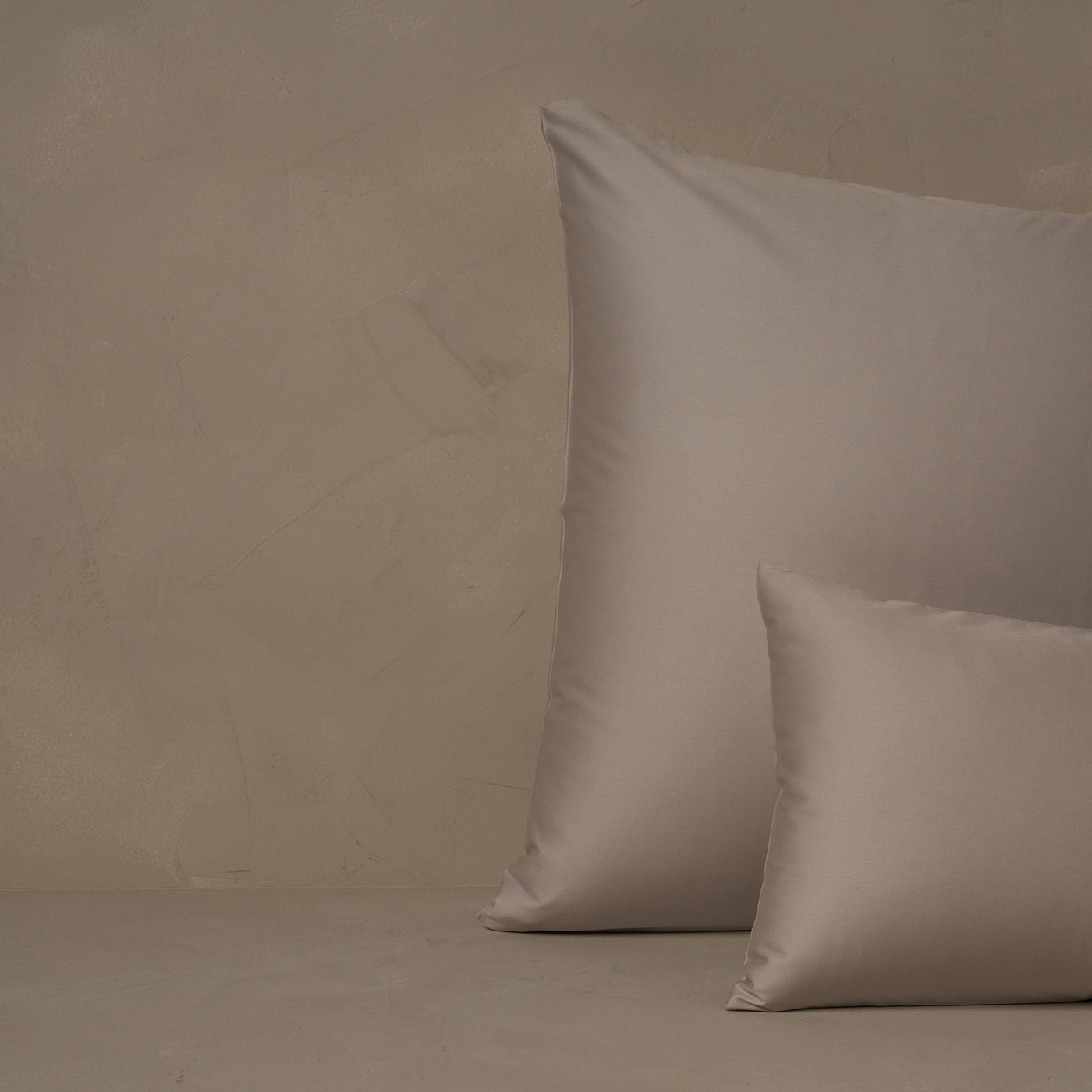 An image of a small boudoir or travel size pillow stacked in front of a large euro size pillow. The pillow cases are made of LETTO's warm and buttery Classic Cotton Sateen in color gray.